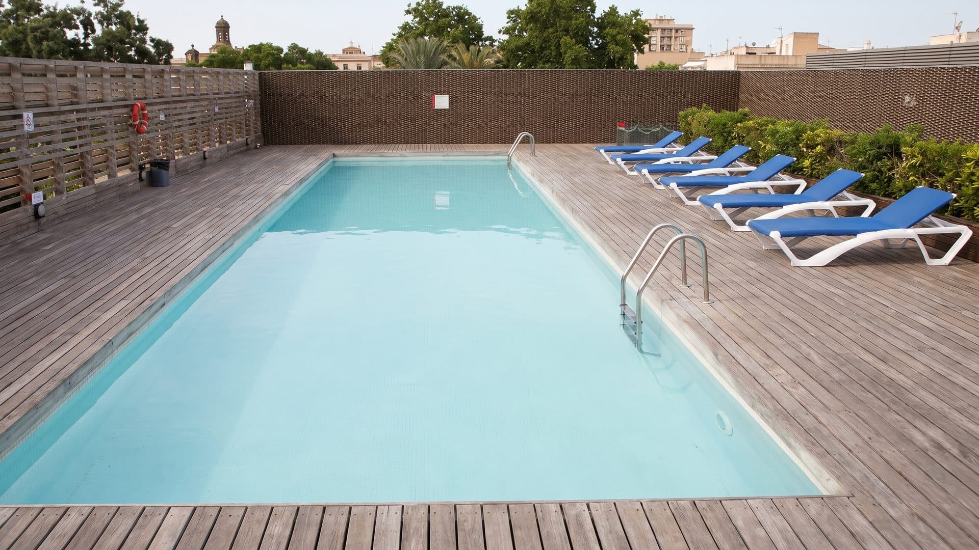 The pool of the Aqua Center with loungers along its timber decking