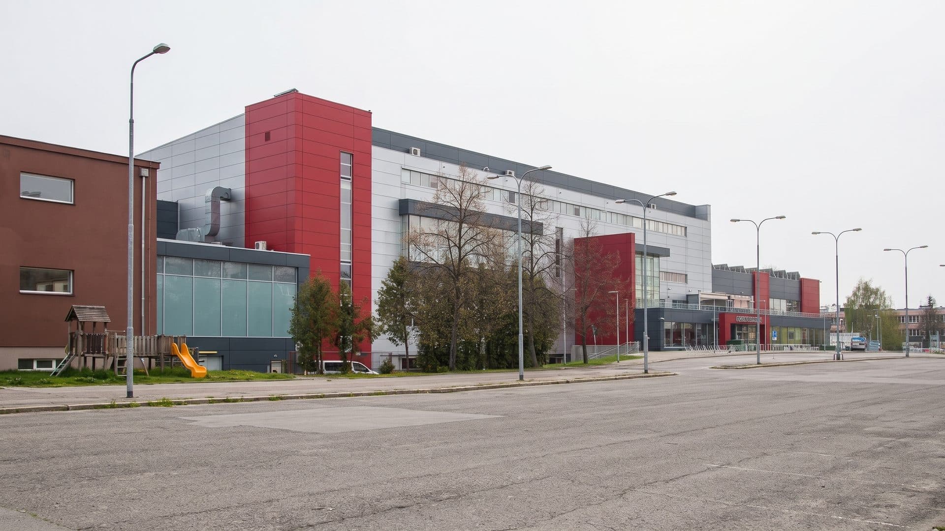 The red and white front of the Pardubice aqua centre across its forecourt