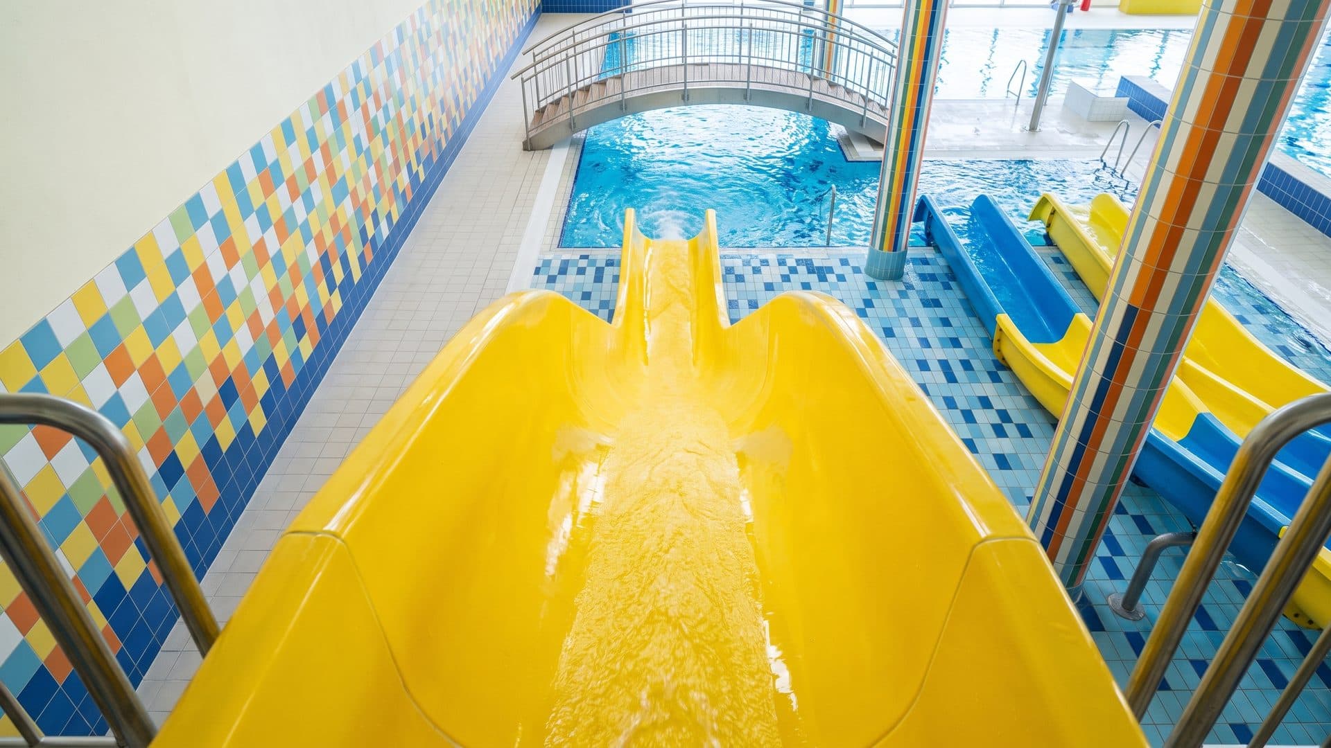 The yellow slide of the Teplice aqua centre running down to its splash pool