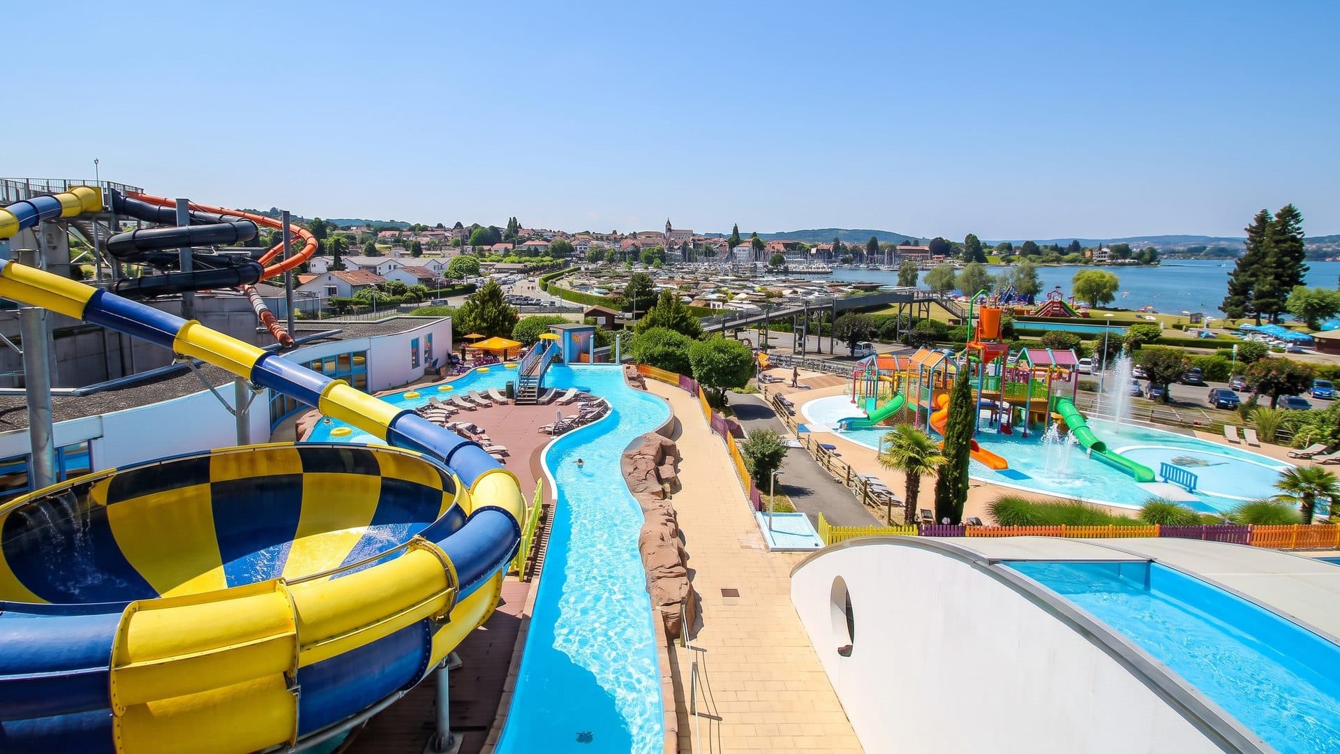 Aquaparc Le Bouveret with its coiled slides above the pools and lawns by the lake