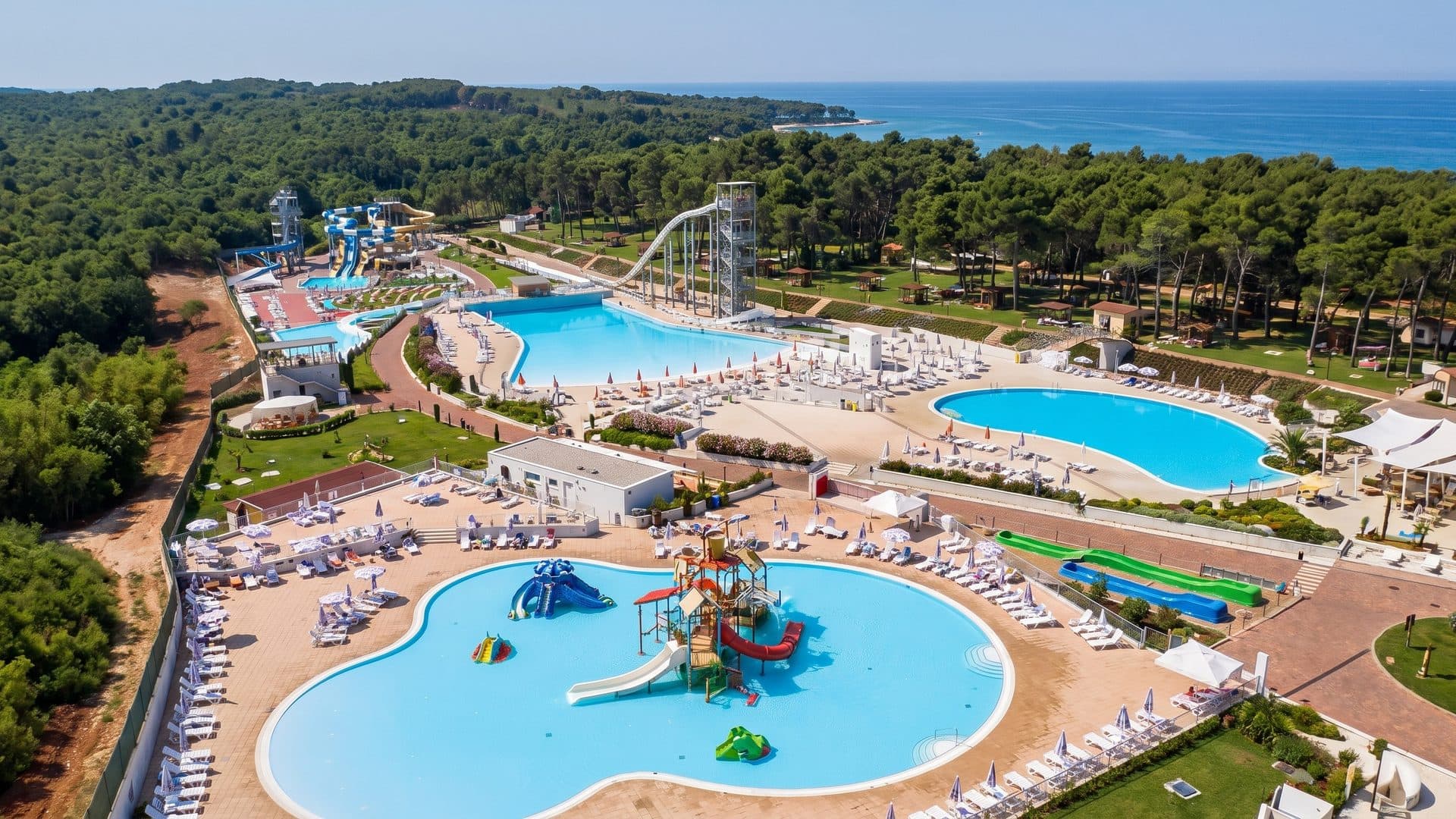 Istralandia from the air with its pools and slides among the pines above the sea
