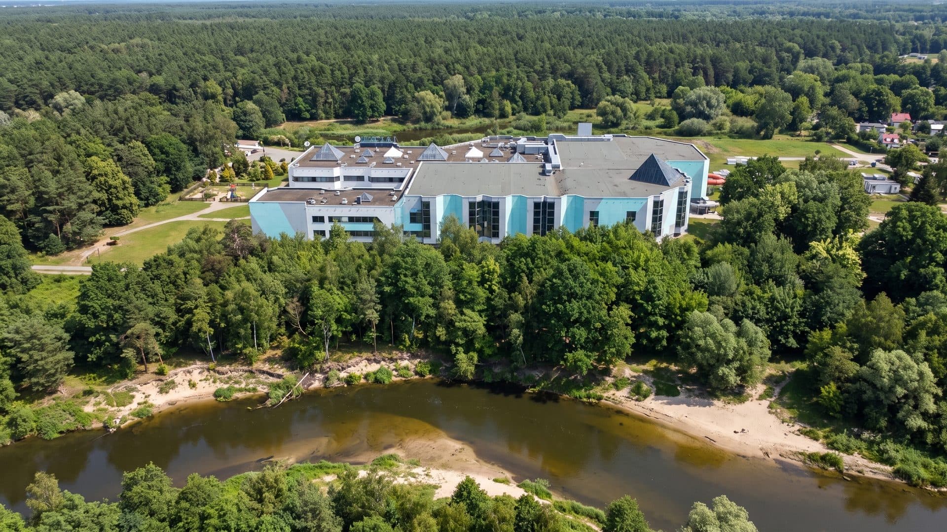 The Laguna baths in Gryfino seen from the air above the river with the forest behind