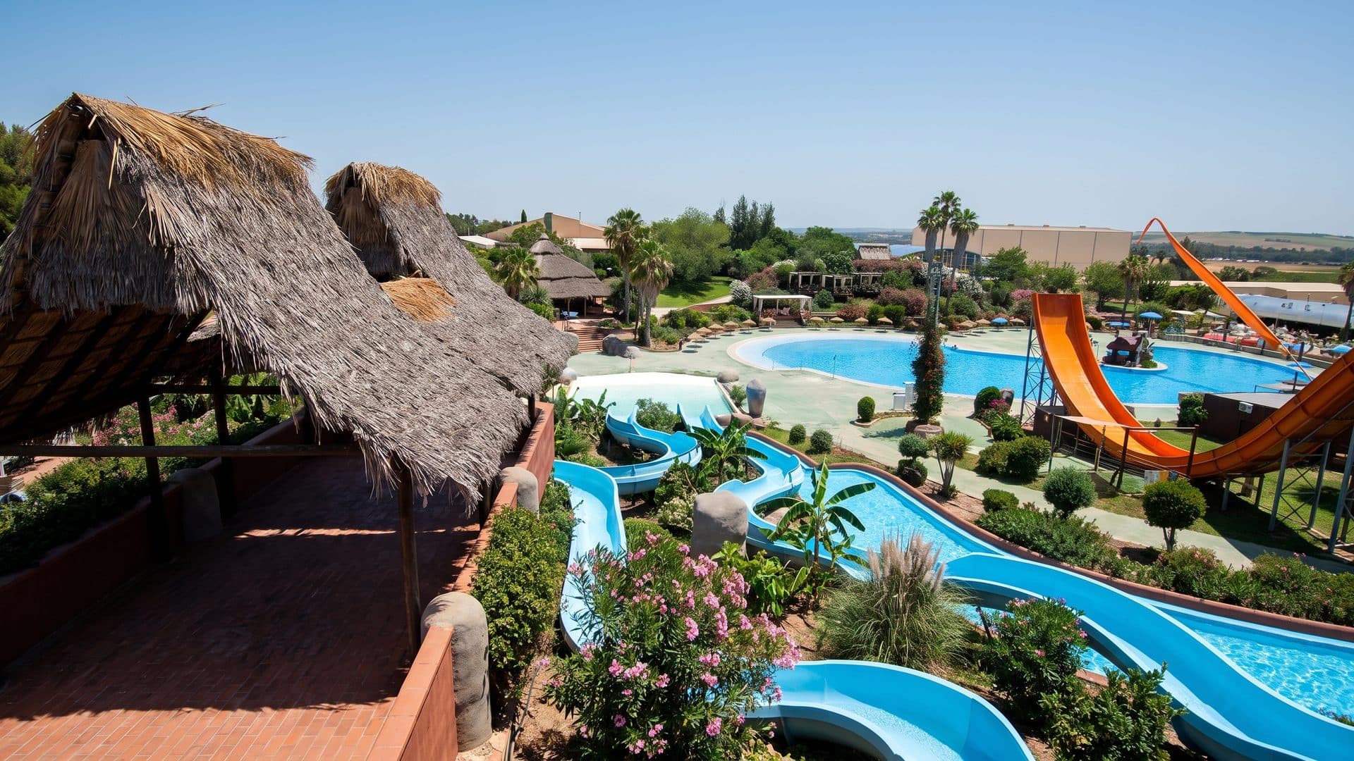 The pools of Aquasierra with their thatched shelters and slides among the planting