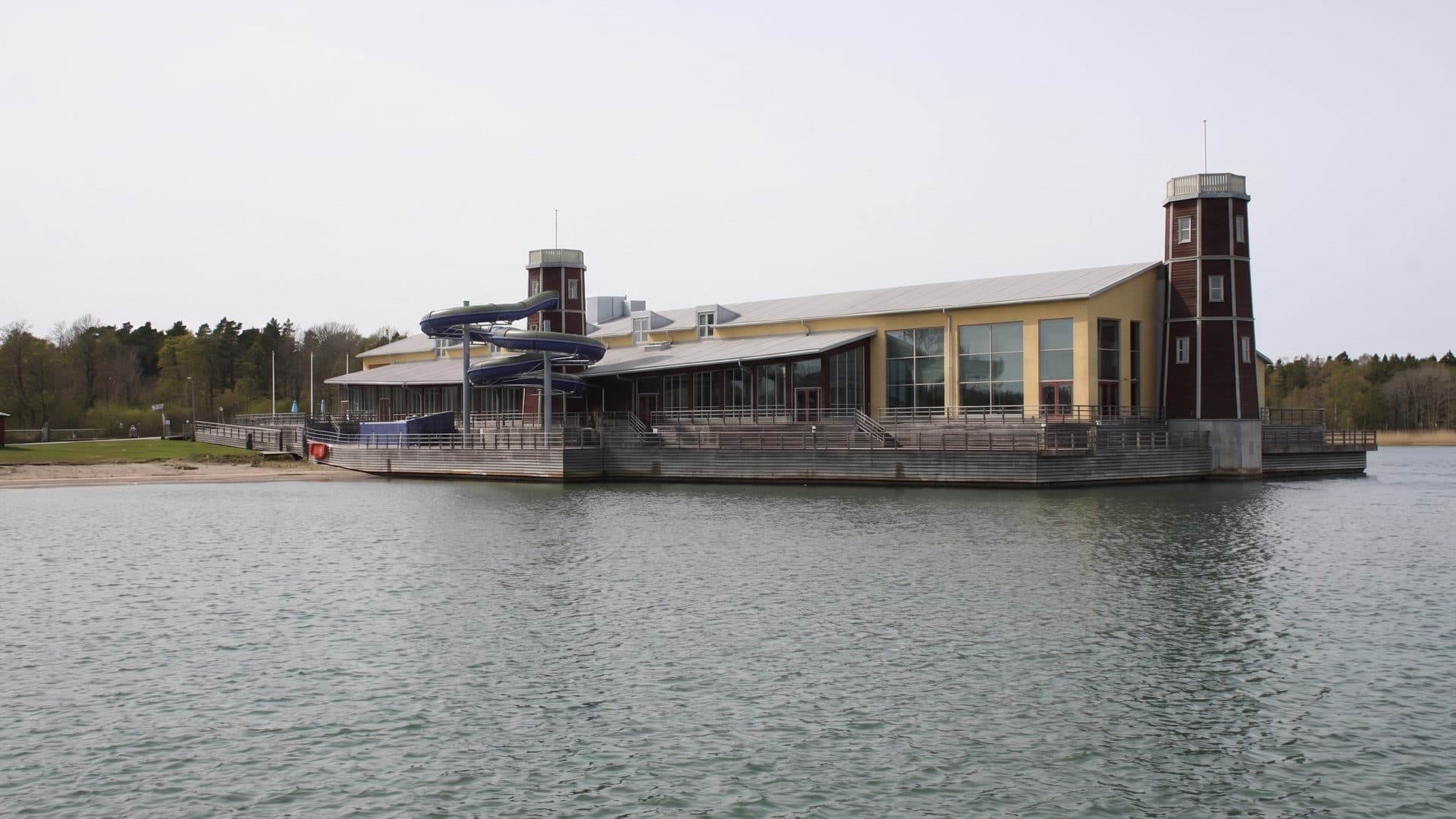 The long waterfront building of the Mariebad adventure baths with its tower seen across the water