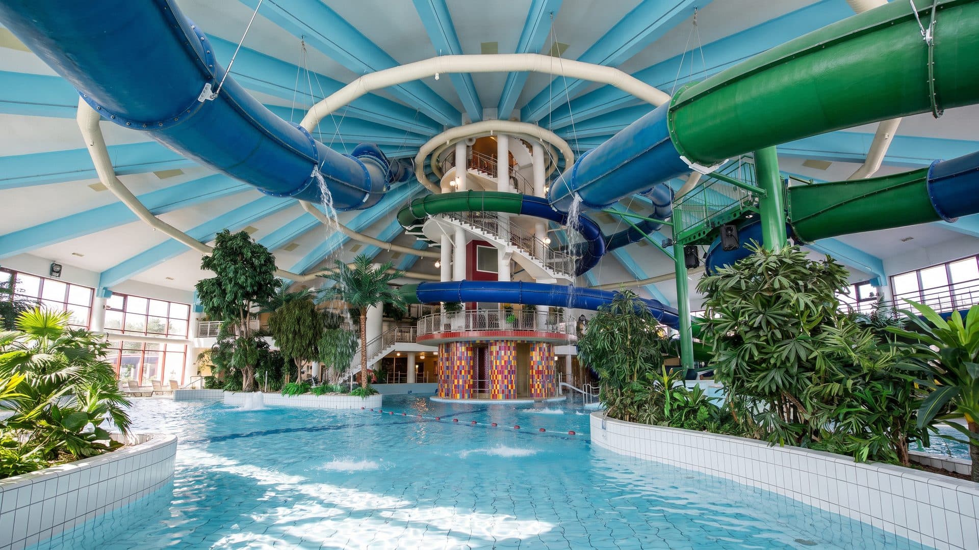 The indoor water park of Aventyrsbadet with its coloured slide tubes above the lagoon pool