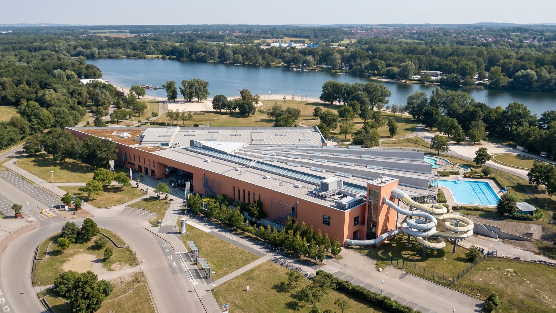 The Badeland Wolfsburg from the air with its pools beside the lake
