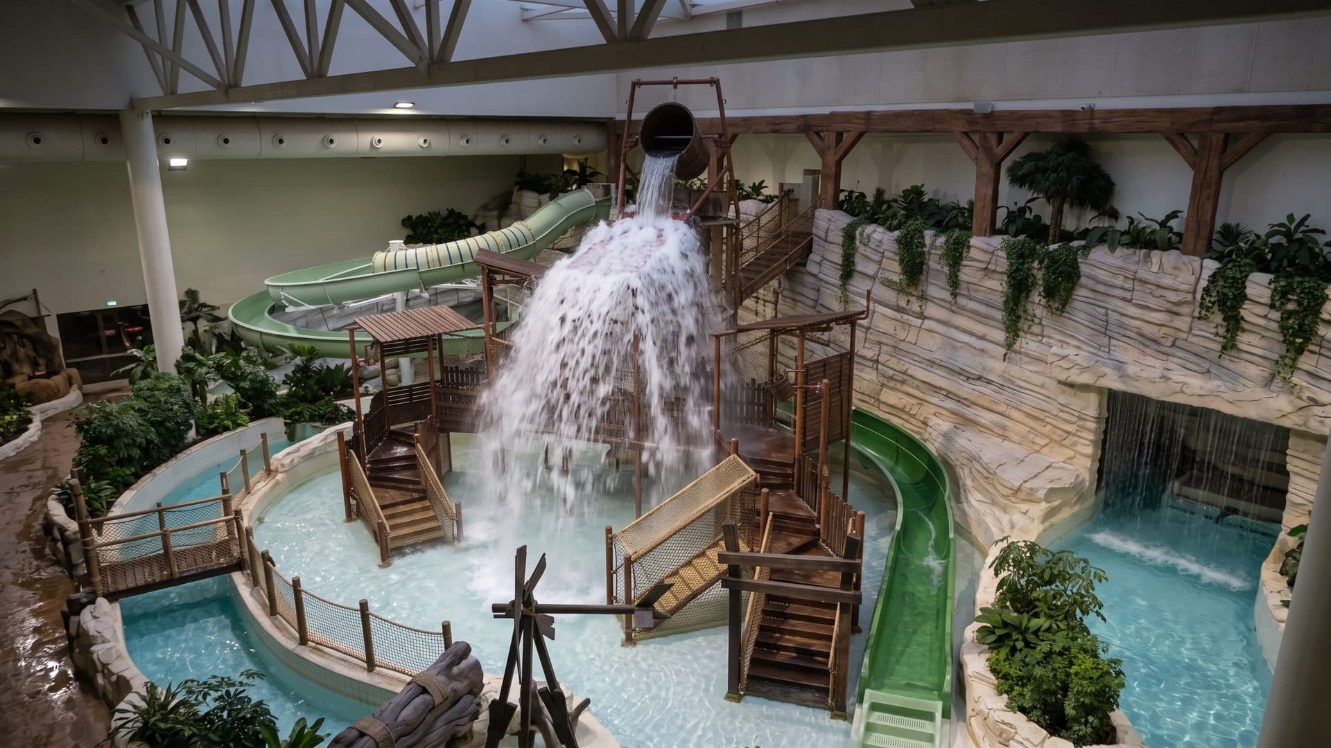 A tipping bucket and timber play structure over the indoor pools of the Bellewaerde Aquapark
