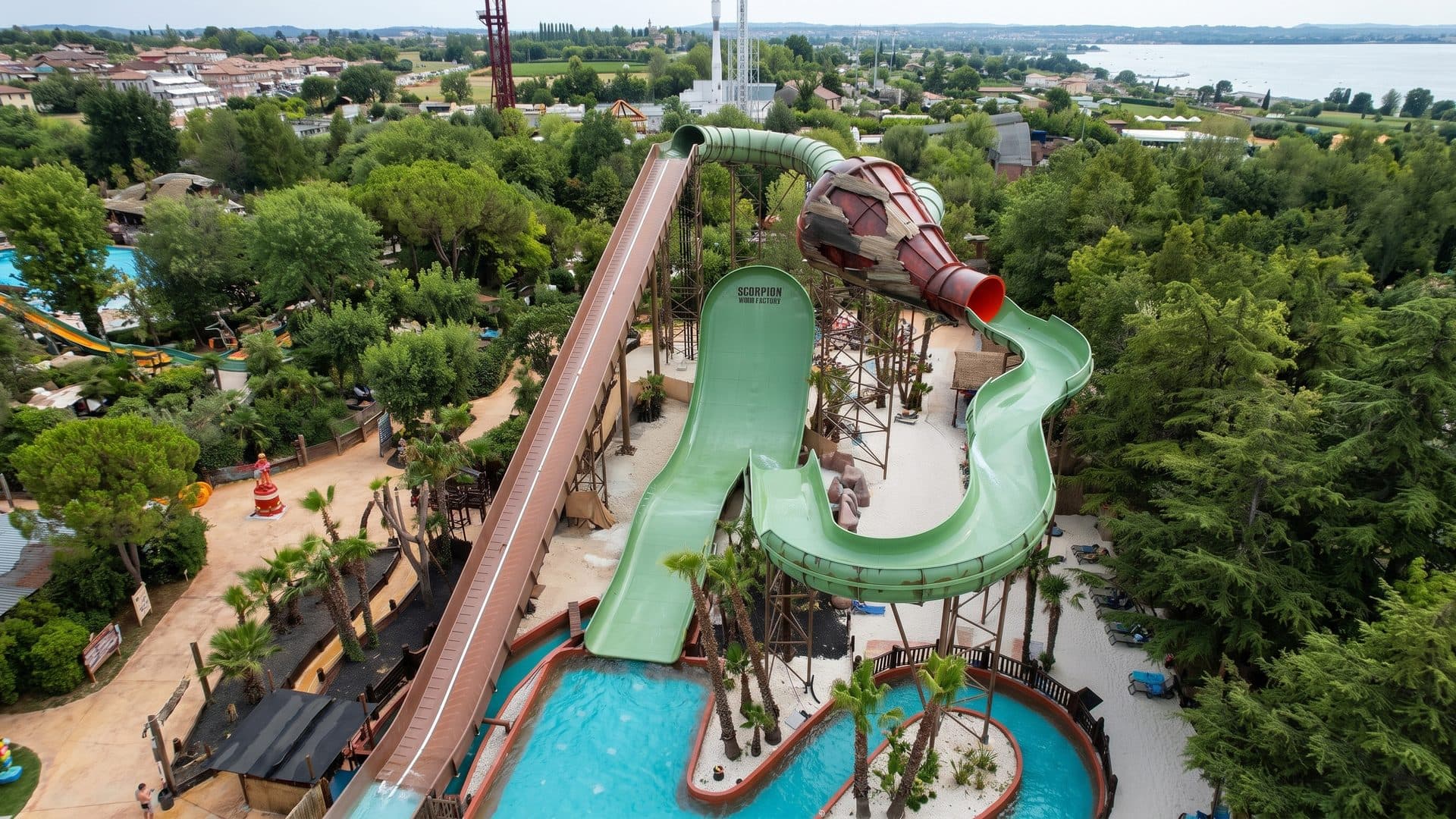Caneva Aquapark seen from the air: coiled slides and pools among the pine woods