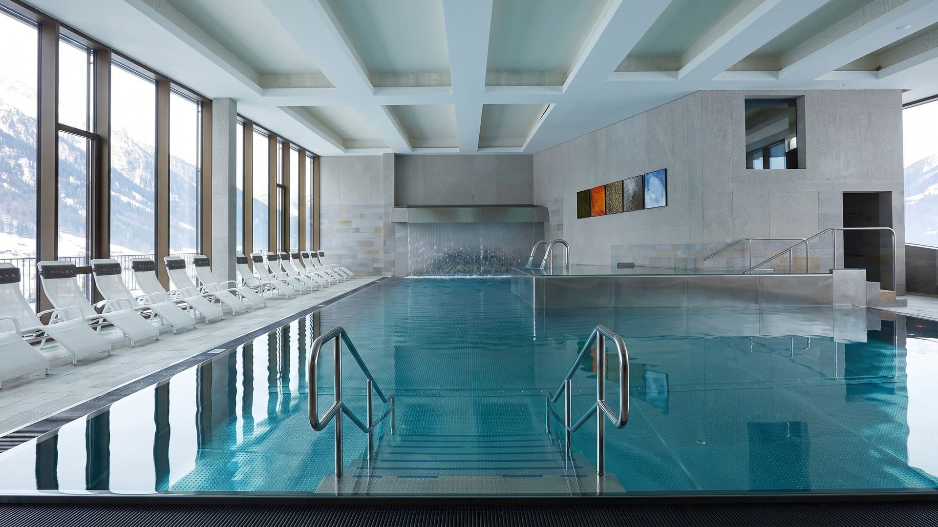 The pool of the Cascade sport centre along its window wall with loungers set out