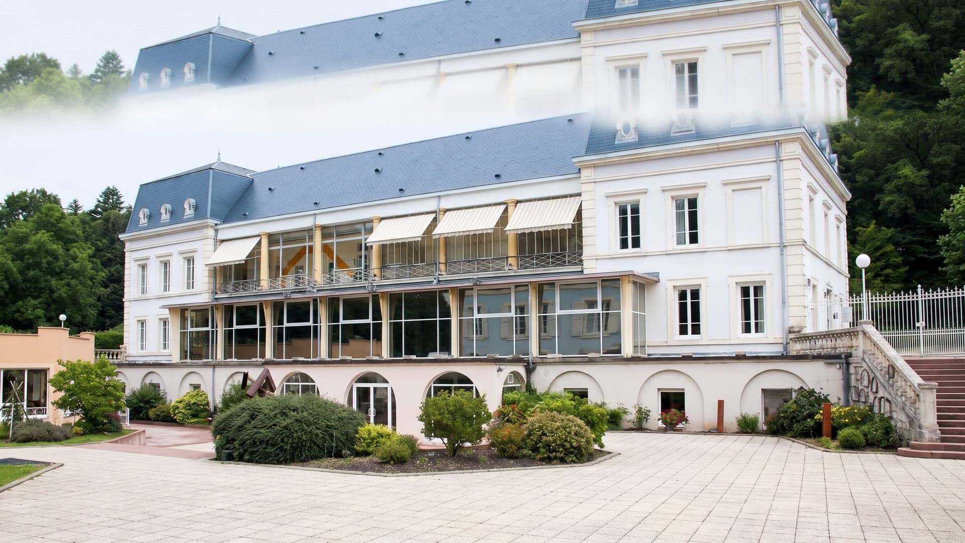 The white building of the Celto baths with its balconies and paved forecourt