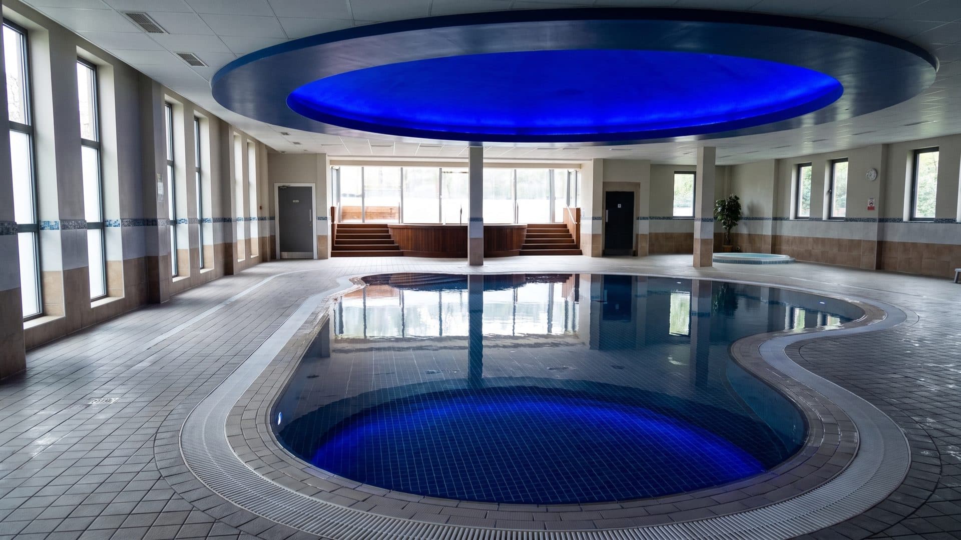 The free-form pool of the Cieleo below the blue oval light of its ceiling