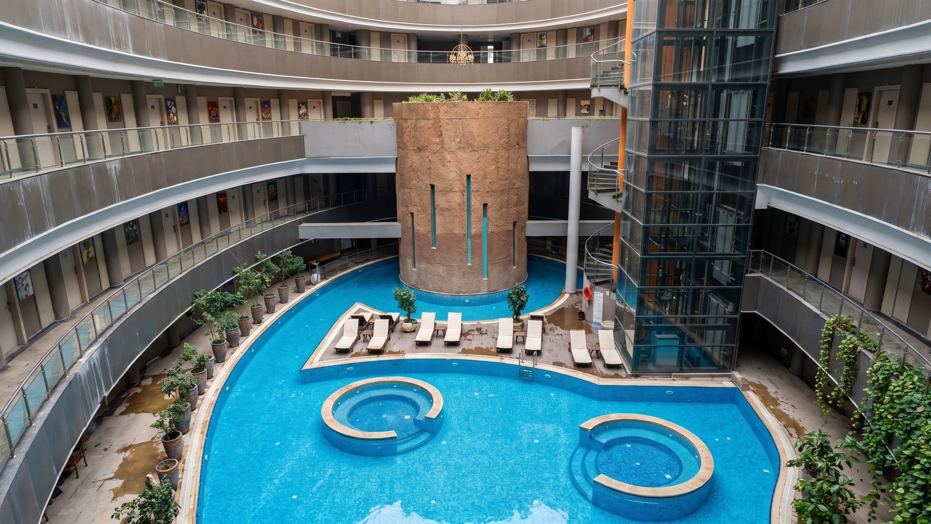 The thermal pool in the atrium of Doga Thermal in Karahayit, ringed by balconies around a brick core