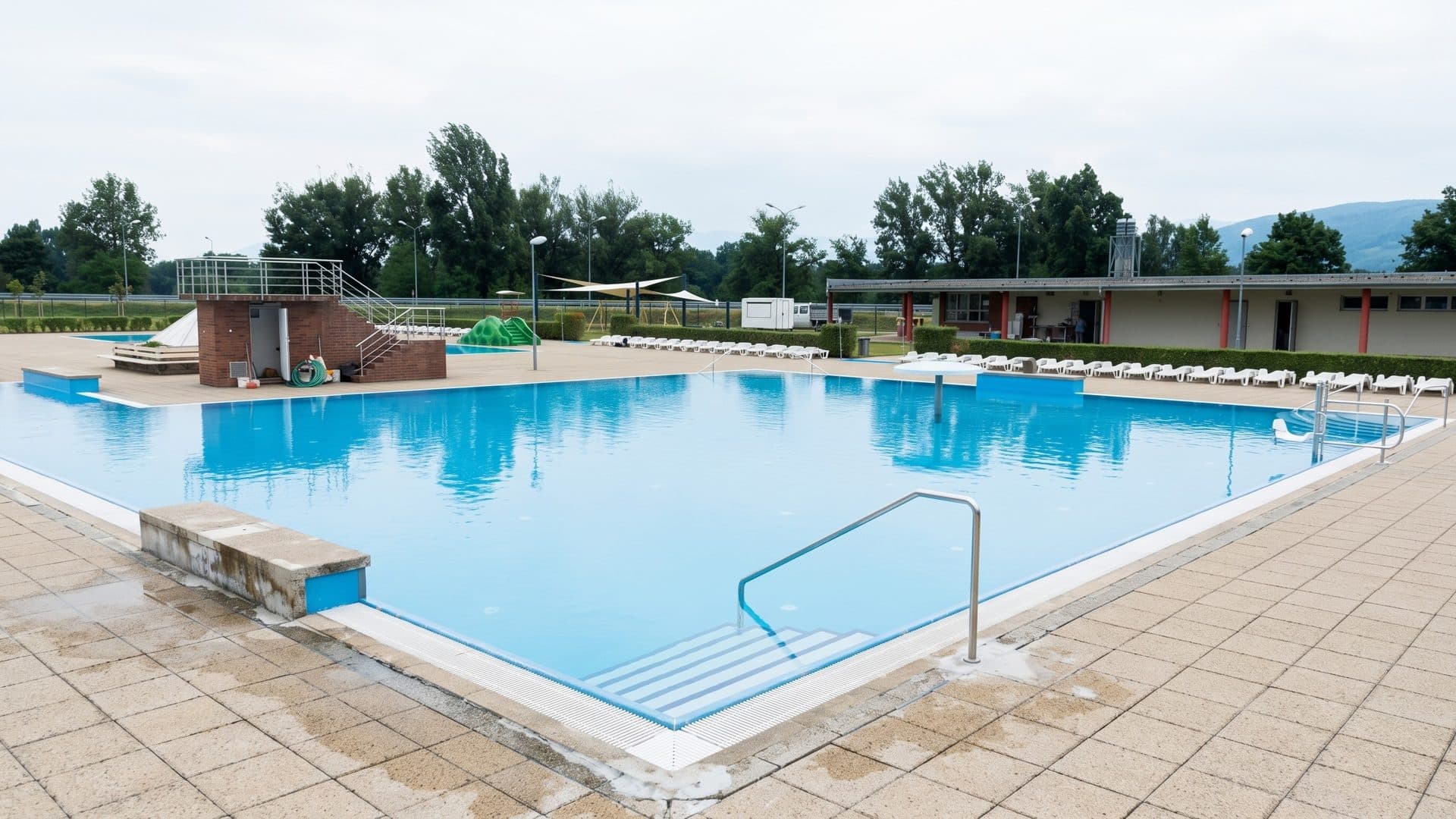 The open-air pool of the Dudinka lido in Dudince with a small tower and changing buildings