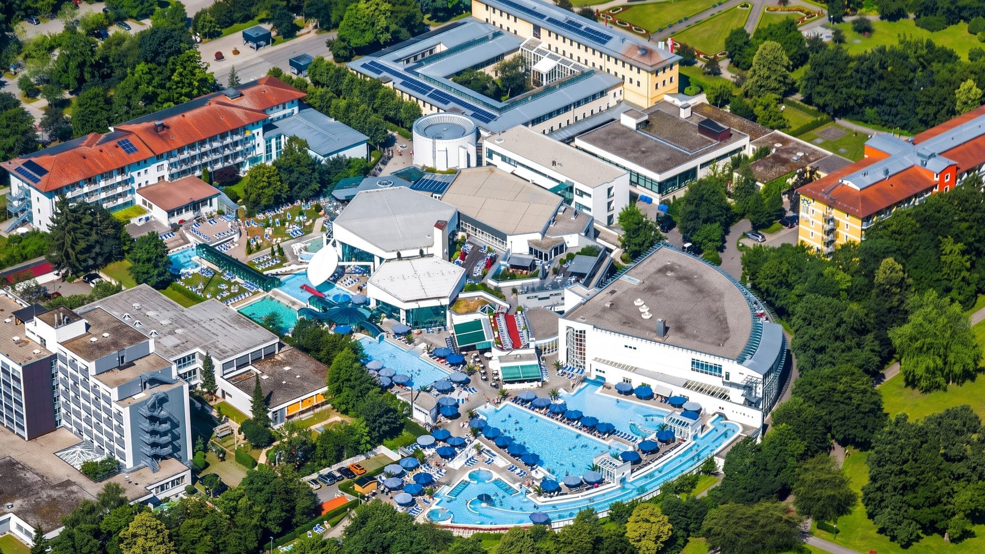 Aerial view of the large spa complex, its blue pools set among hotel buildings