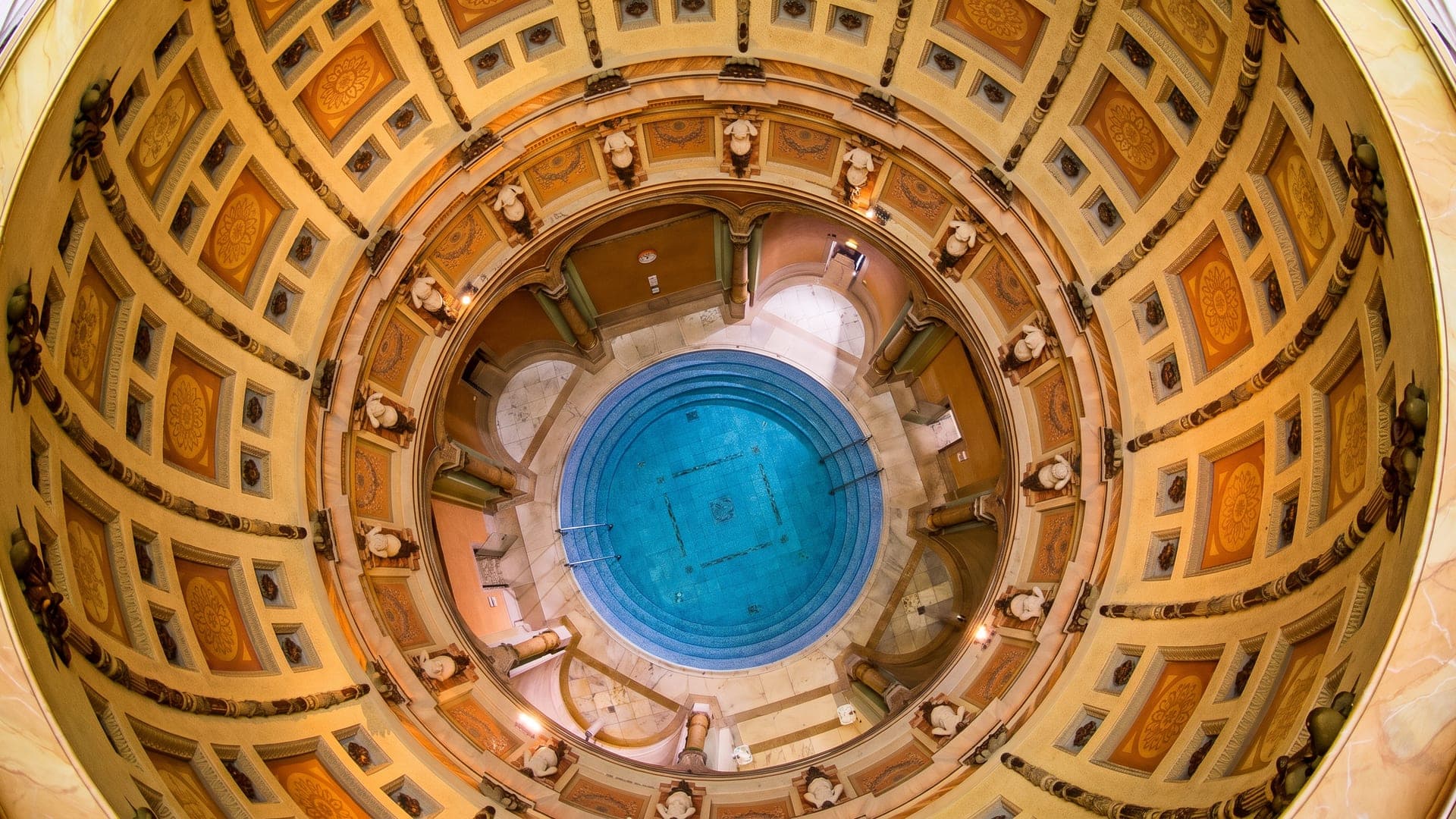 Looking up into the coffered dome above the circular blue pool