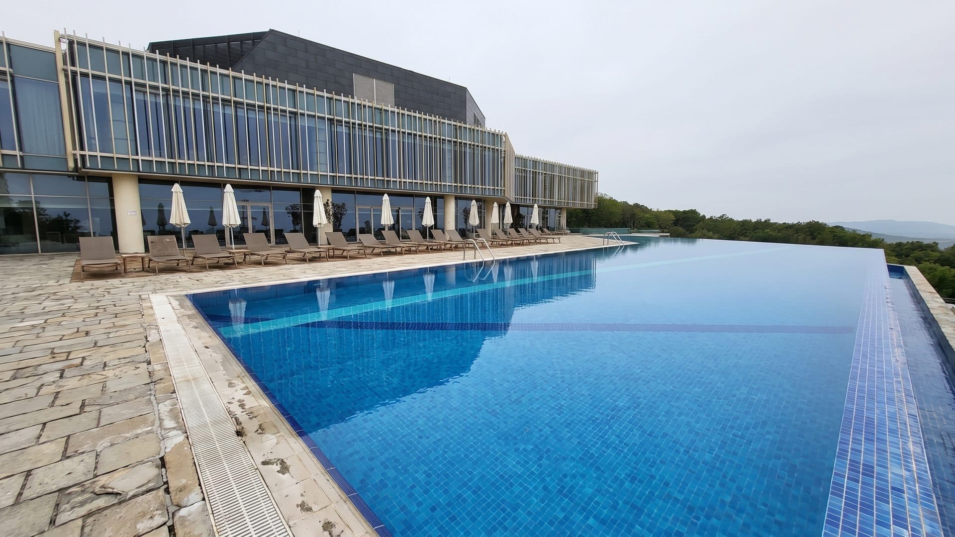 The long outdoor pool running along the glazed front of the Galaalti sanatorium building