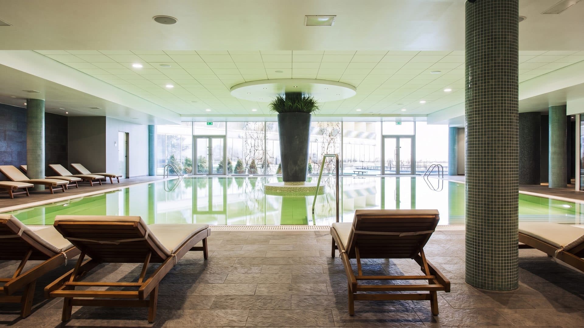 The indoor pool at the Georg Ots Spa in Kuressaare, with loungers along the glazed wall