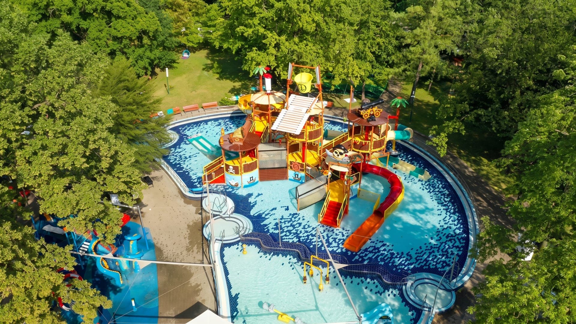 Aerial view of the children's water playground and its slides among trees
