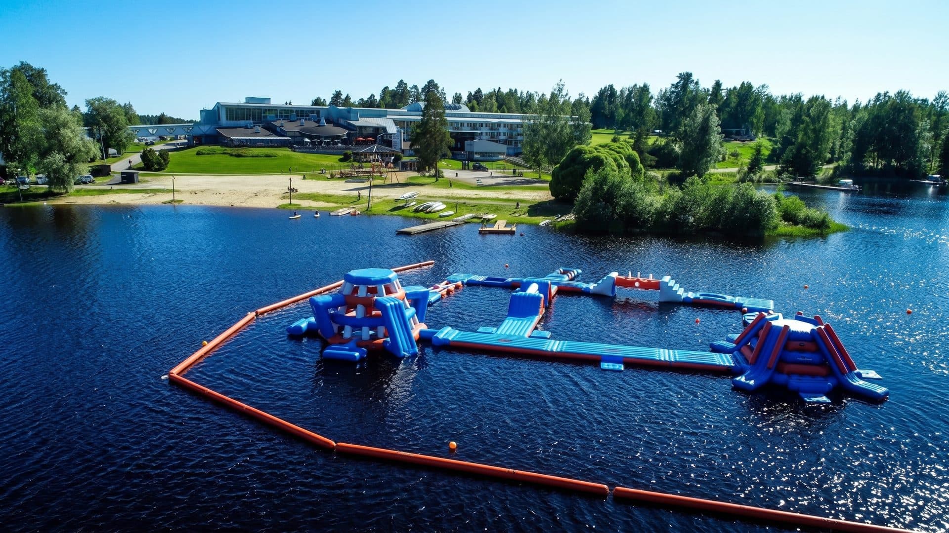 The floating water park on the lake at Ikaalinen with its inflatable platforms and the wooded shore behind