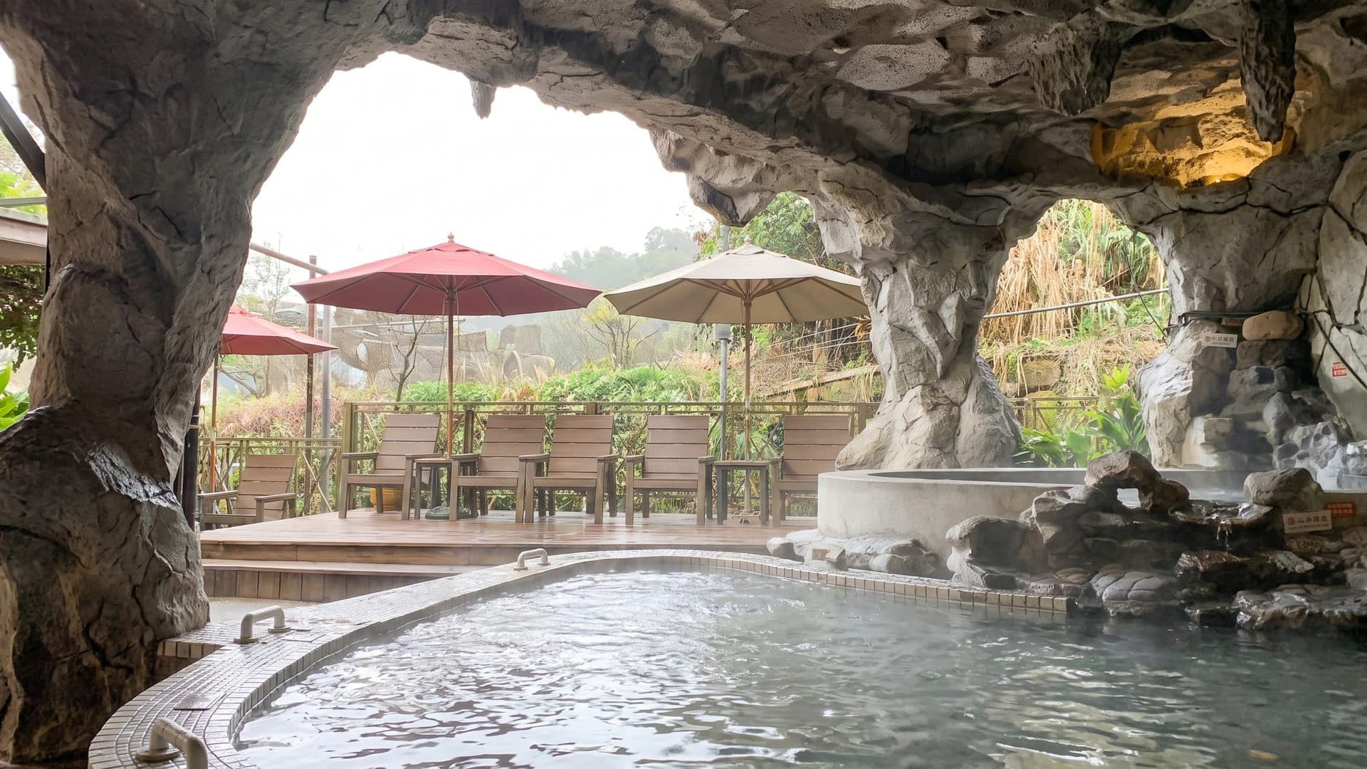 The rock-vaulted bath at King's Garden in Guanziling, its mud-spring water under the stone arches