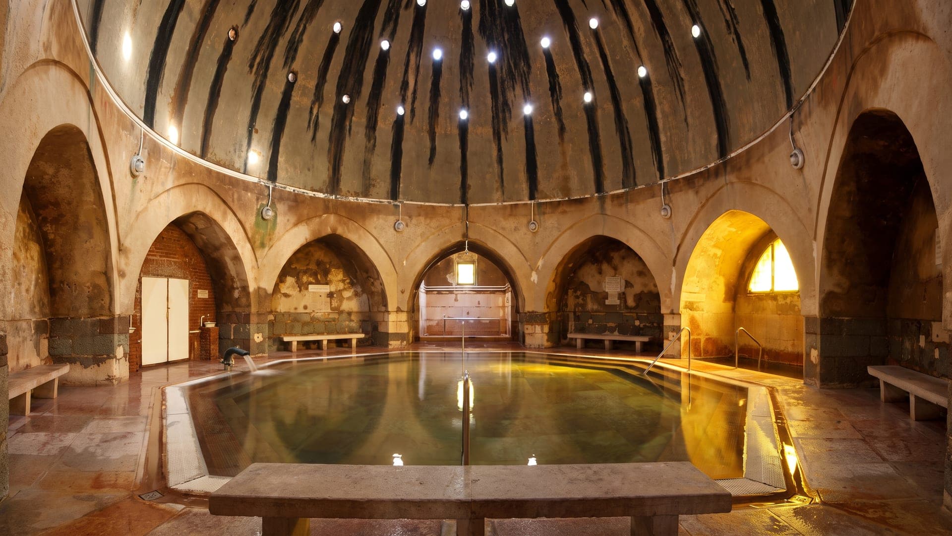 Octagonal Ottoman pool beneath the domed vault, pierced by star-shaped lights