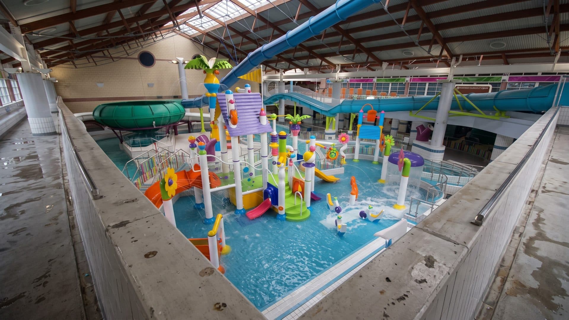 The indoor children's water play area of the Lagan Valley LeisurePlex with a colourful castle structure and slides