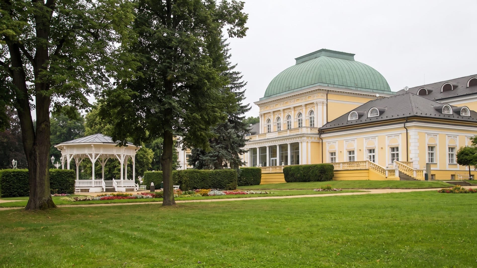 The spa house of Lazne Slatinice with its domed pavilion seen across the park