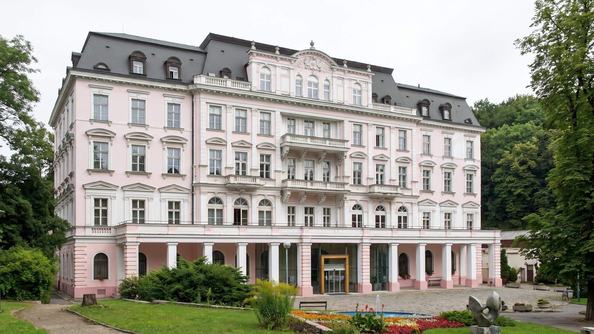 The white spa hotel of Teplice v Cechach seen across its park lawn