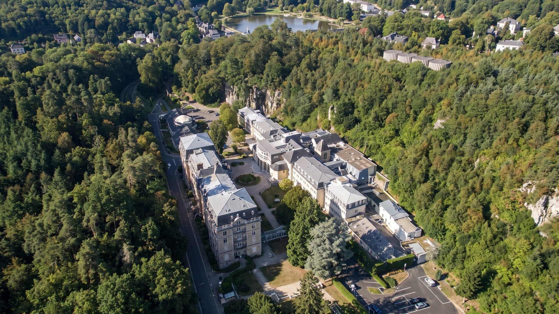 The baths of Bagnoles from the air: the spa buildings and their park among wooded hills