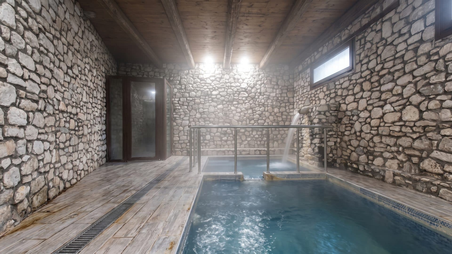 The vaulted stone bathing hall at Pozar, its blue thermal pool lit by daylight from the far door