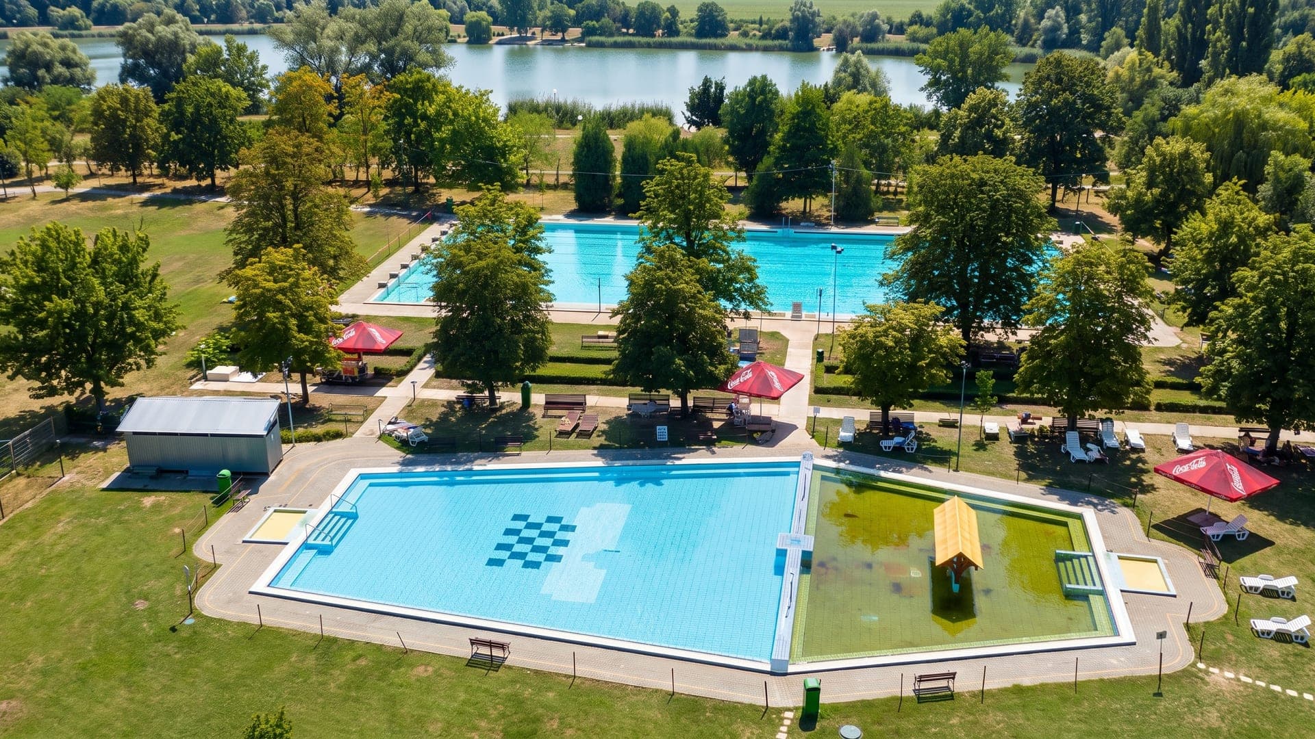 The open-air bath at Mezotur seen from the air, its two pools among mature trees.