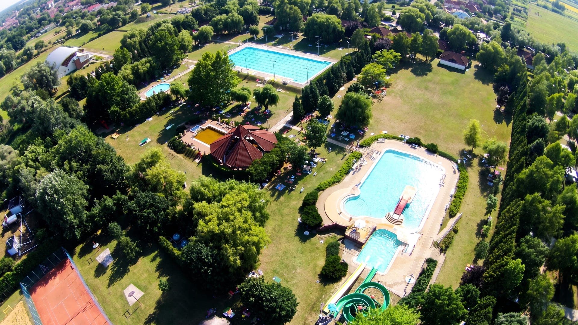 Aerial view of the outdoor pools and lawns among trees