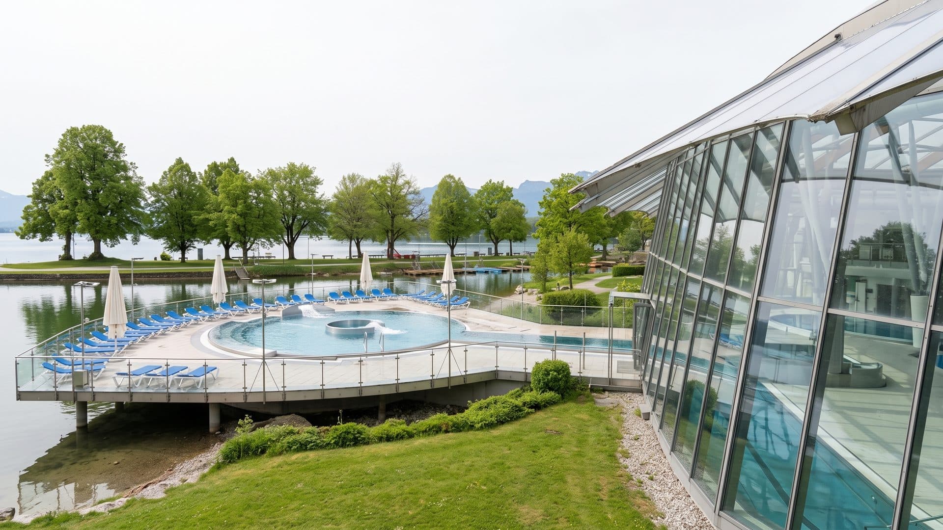 Outdoor pool terrace on the lake shore beside the glass hall of the baths.