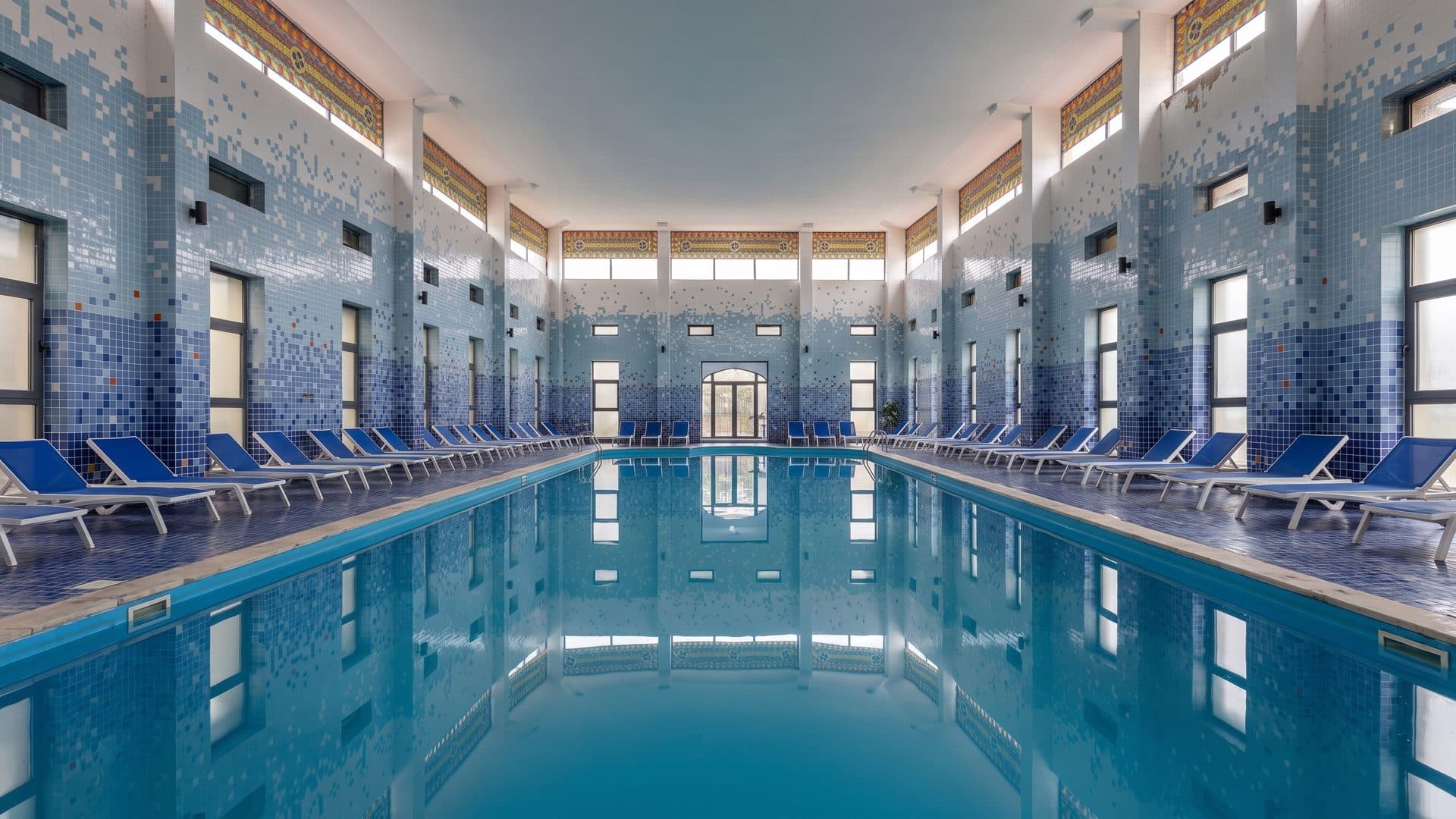 The indoor pool at the Sairme resort, its mosaic-clad walls and columns along the water