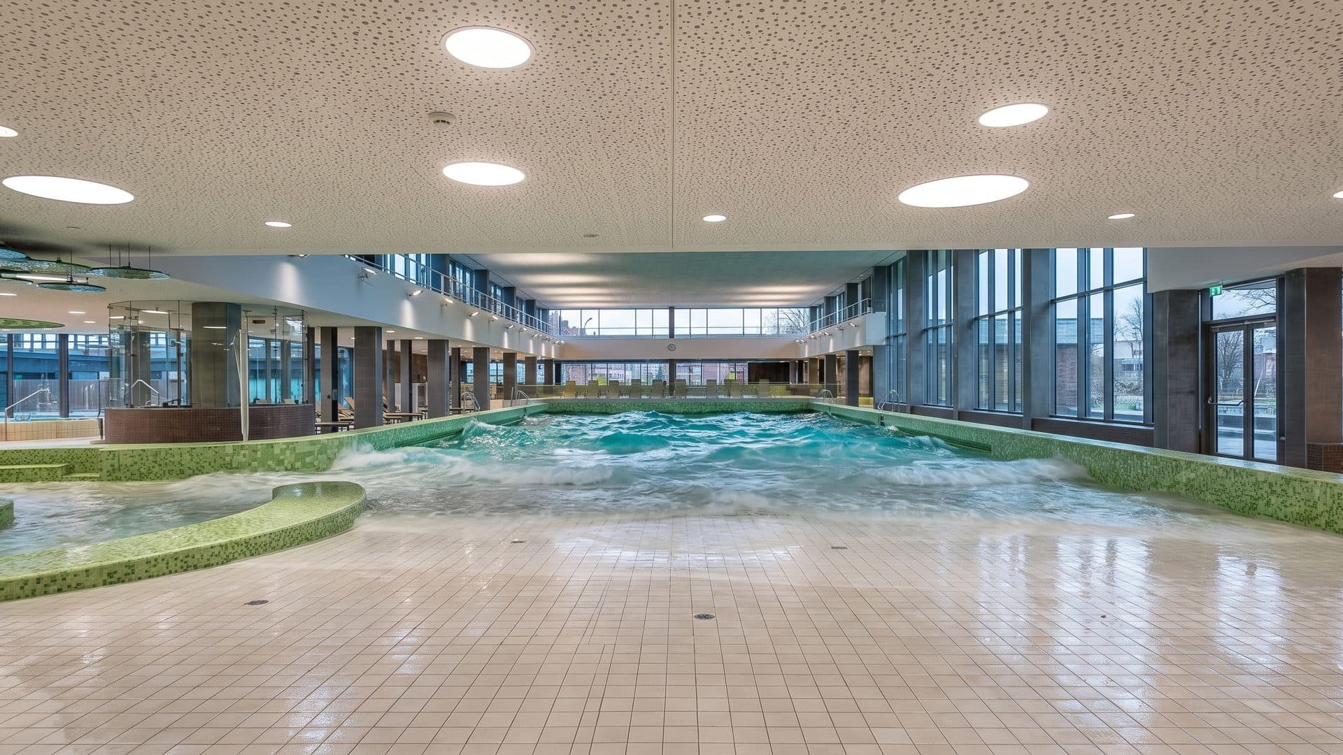 The brine pool hall of the Salztherme in Luneburg, its glazed wall at the far end and a round ceiling light above