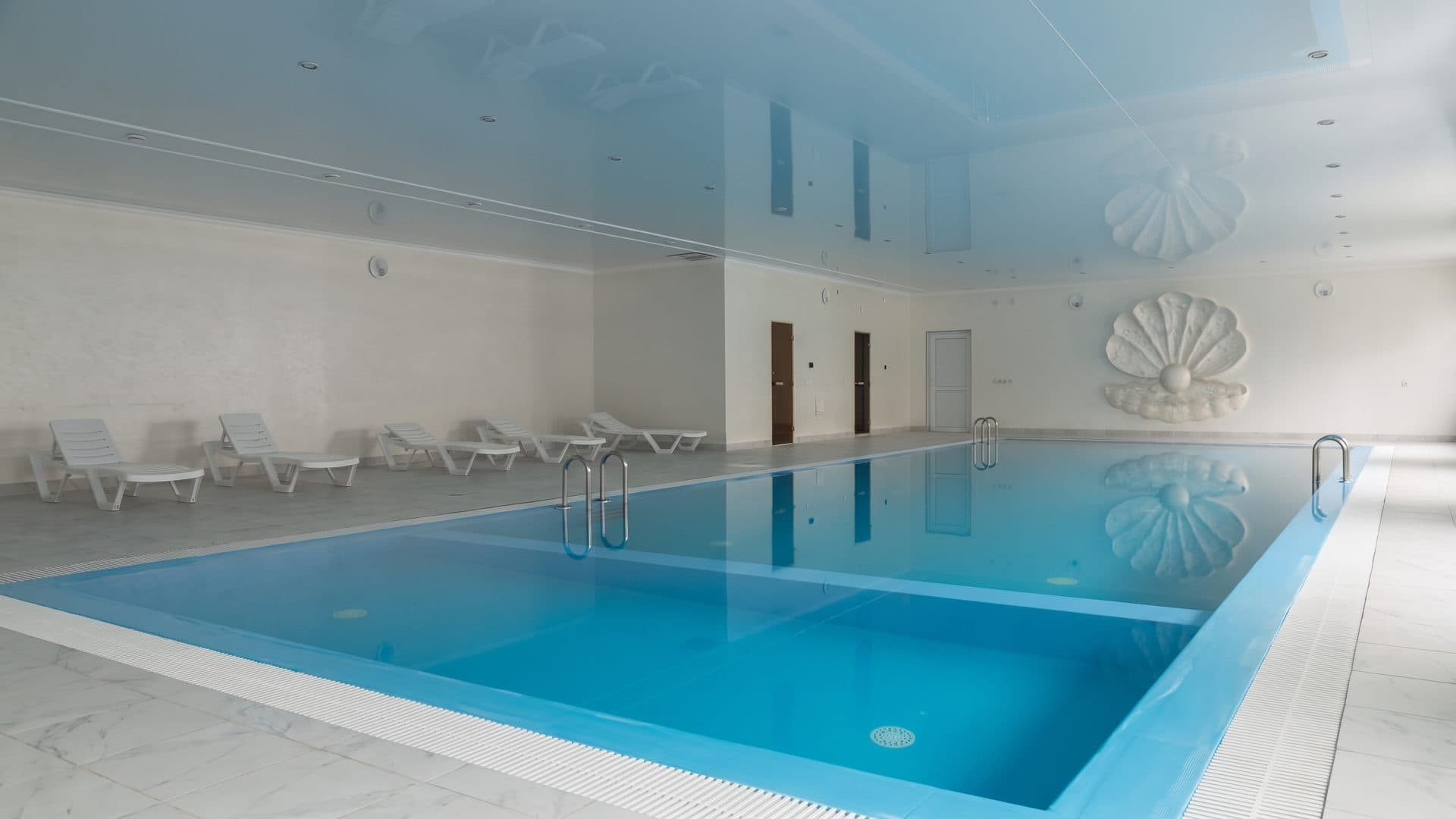 The indoor pool at the Oxy sanatorium in Saryagash, loungers along the wall