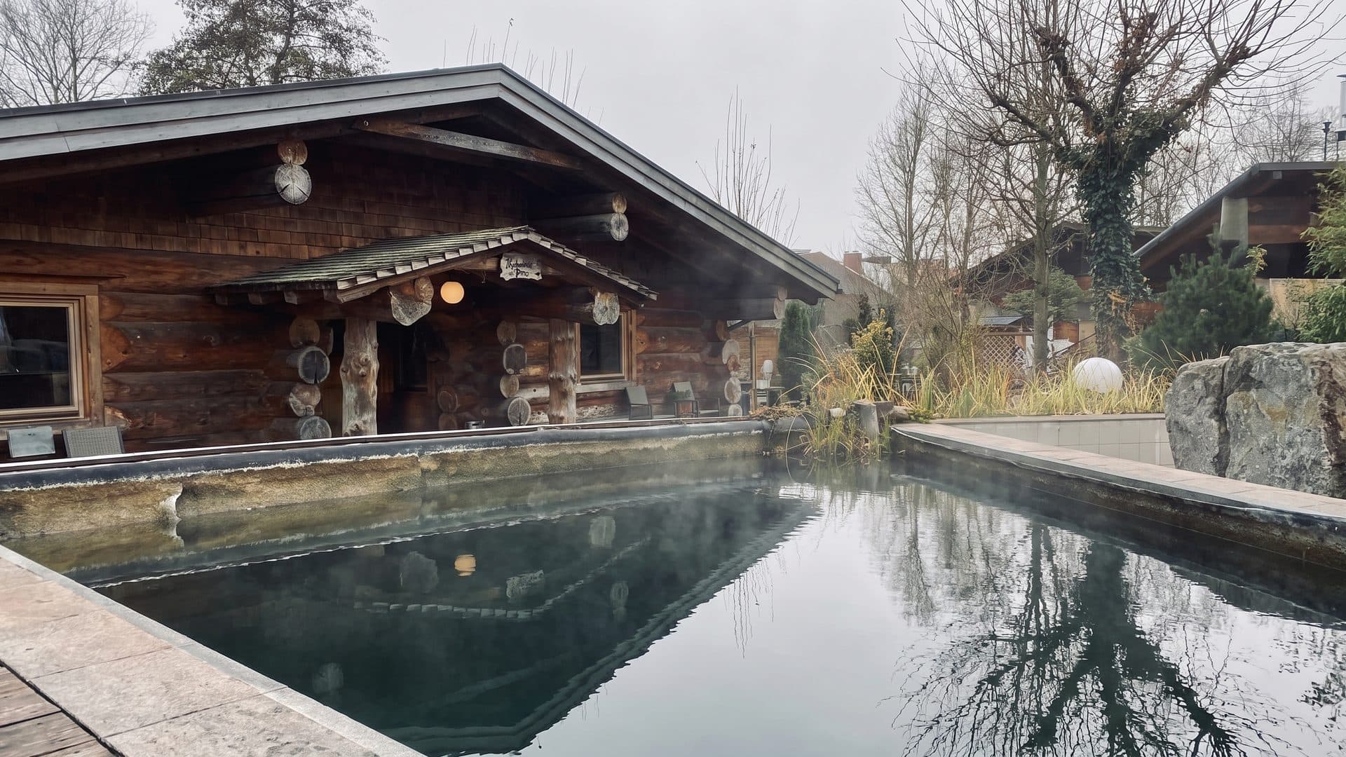 The timber sauna house of the Roeder-Thermen sauna garden beside its steaming outdoor pool