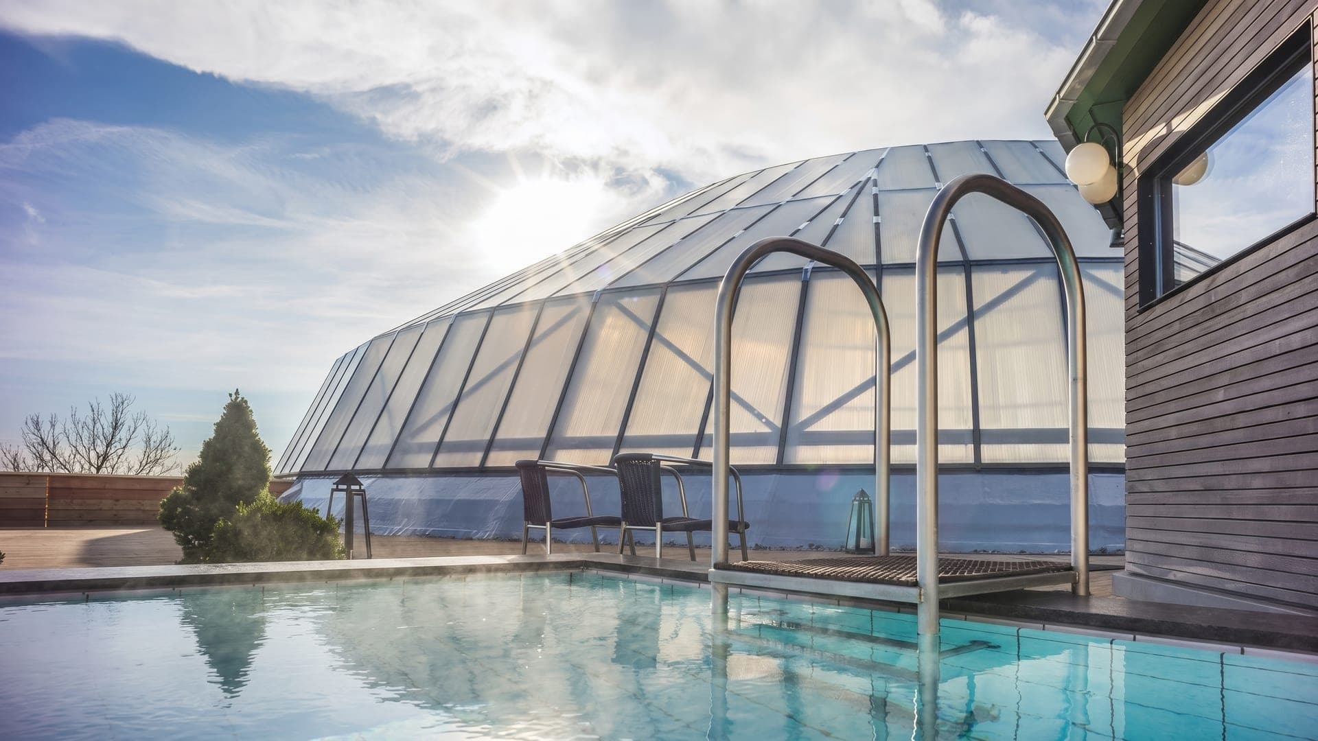 Pool beneath a glass dome carried on a metal frame