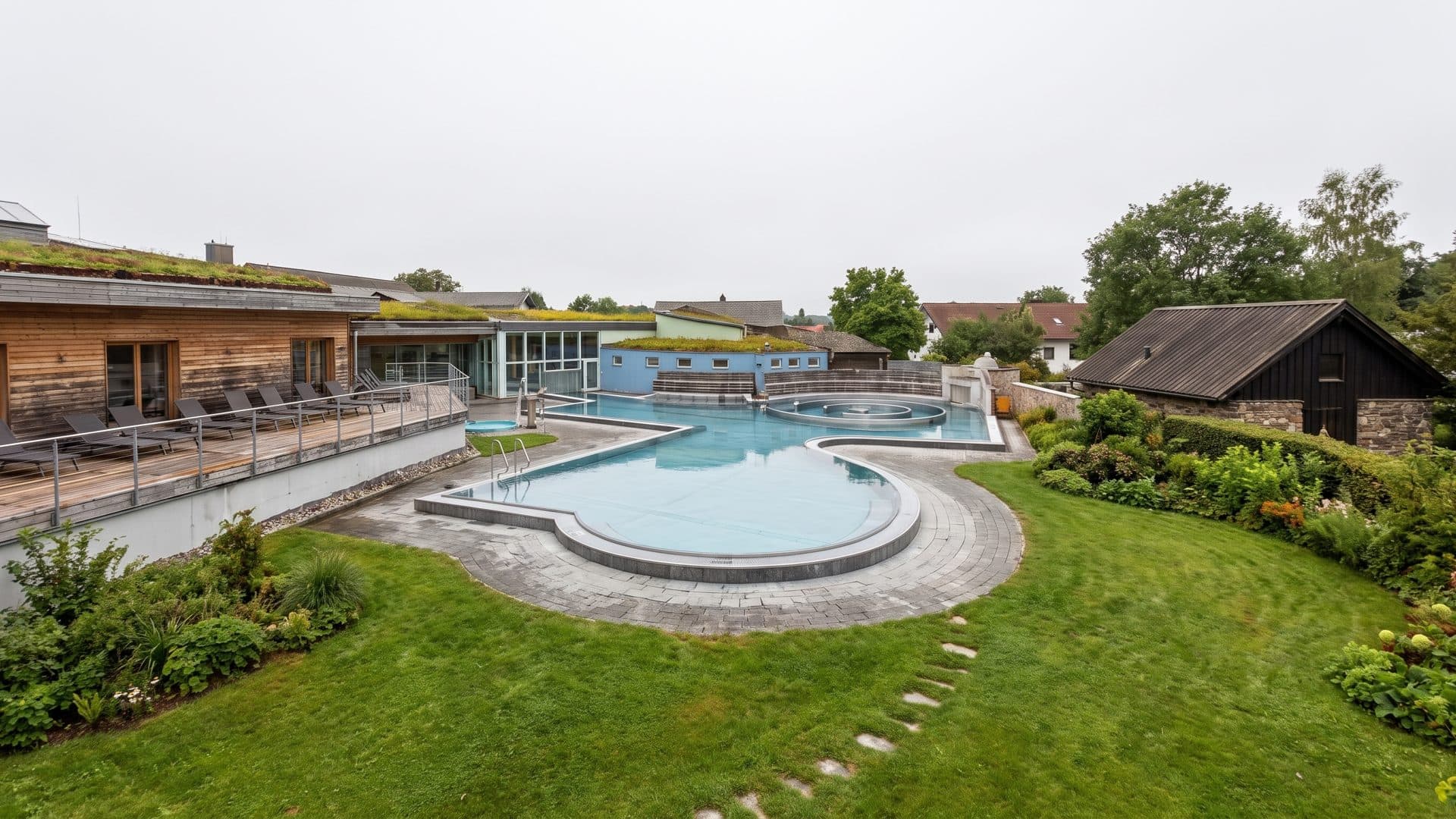 The outdoor brine pool and sauna garden at Sole Uno in Rheinfelden, seen from the edge of the grounds.