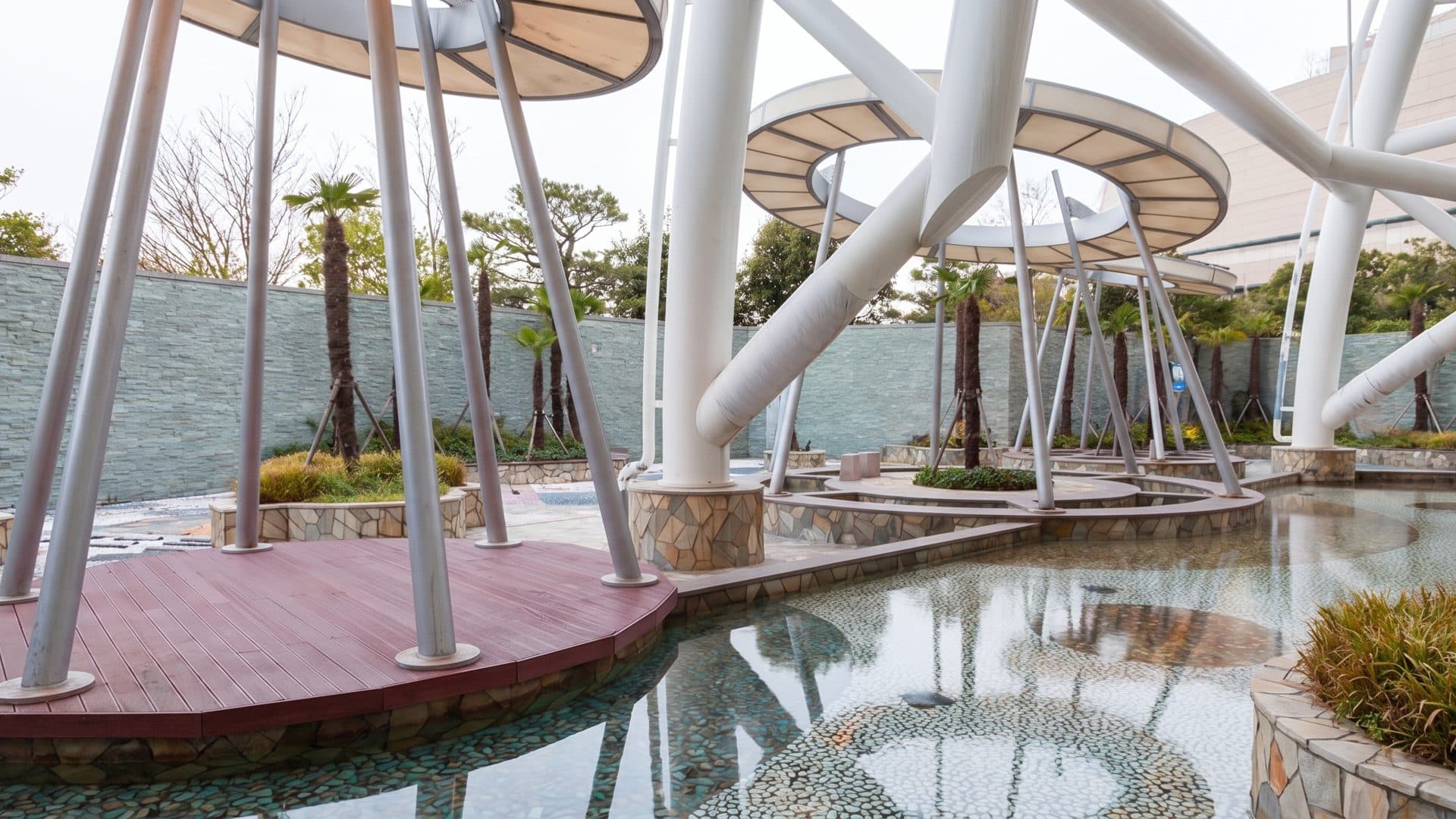 The outdoor foot bath at Spa Land Centum City in Busan under its white canopy on splayed columns