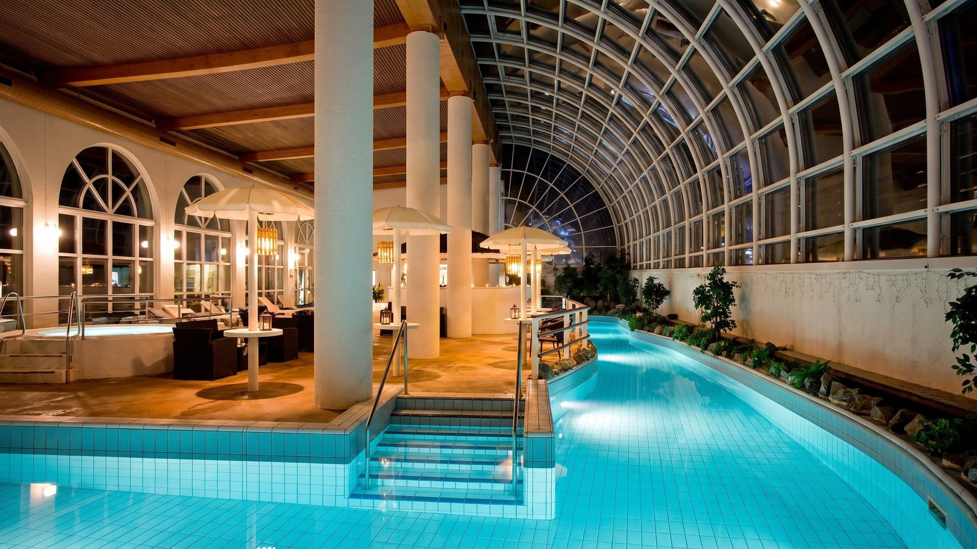 The spa hall of SaniFani with its columns and arched glazing above the pool