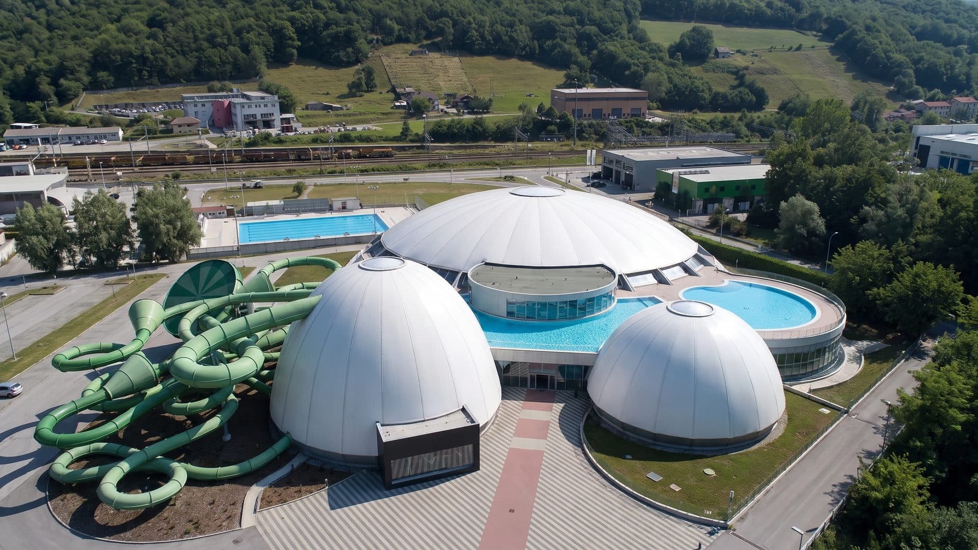 Splash e Spa Tamaro from the air: its white domes and pools among the wooded hills