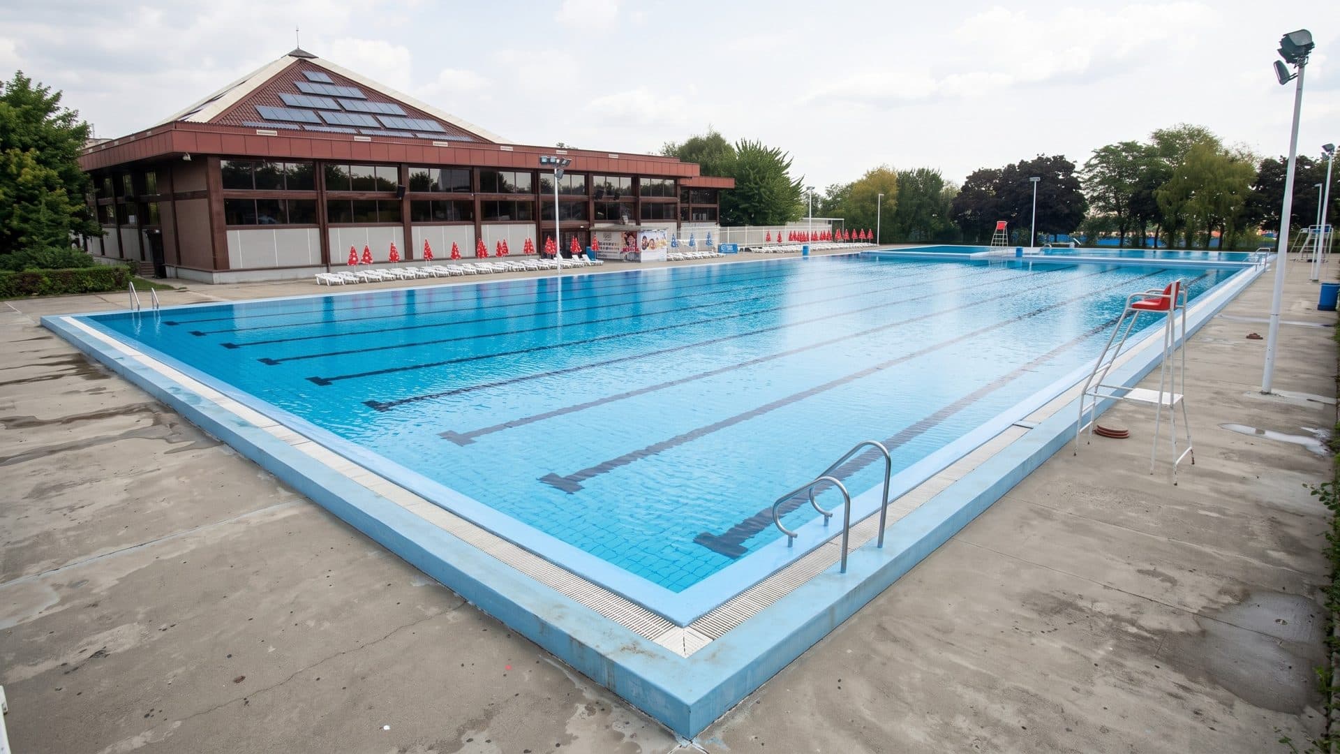 The long outdoor lane pool of the Samar centre in Ribarska Banja beside the red-roofed glazed pavilion