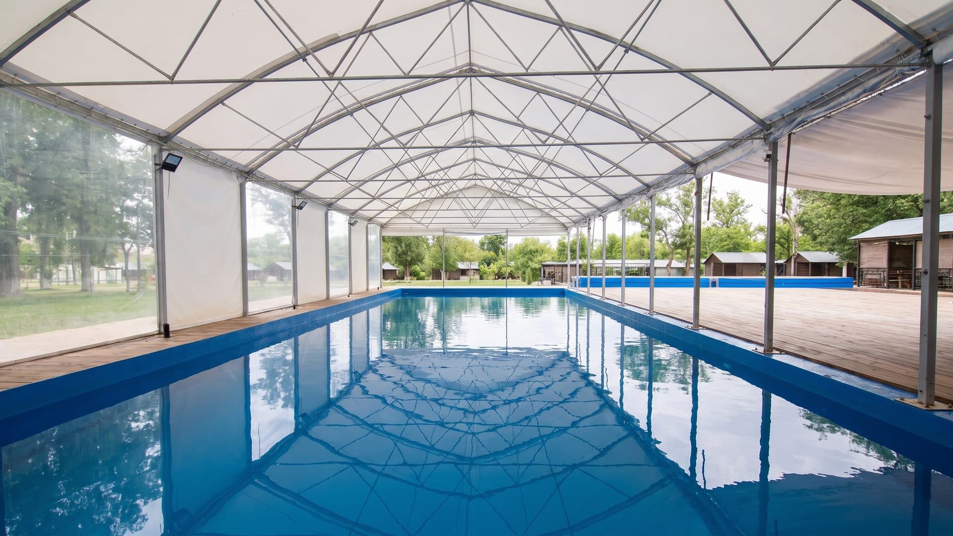 The covered thermal pool at Sacueni under its tent structure with the garden beyond