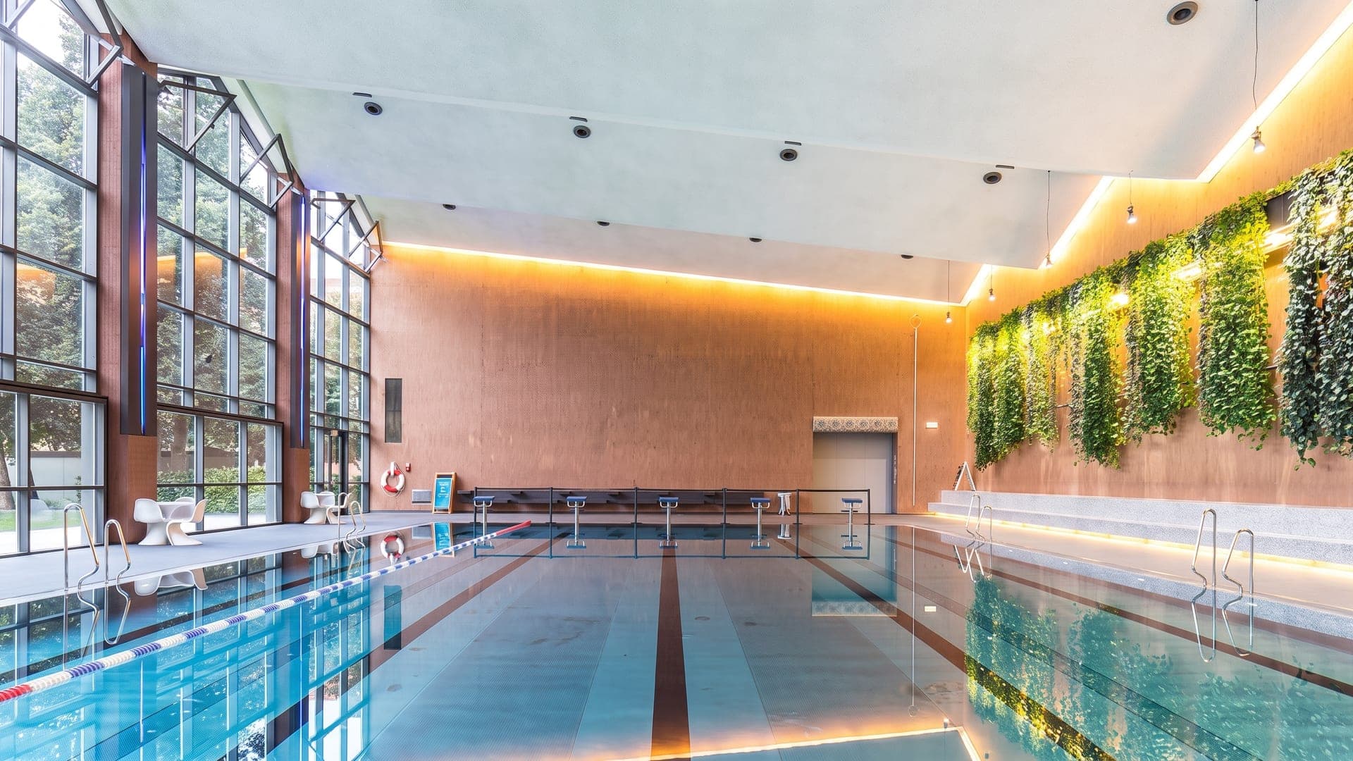 The lane pool of the Suedbad under a barrel-vaulted ceiling, with daylight from the high windows on the water.