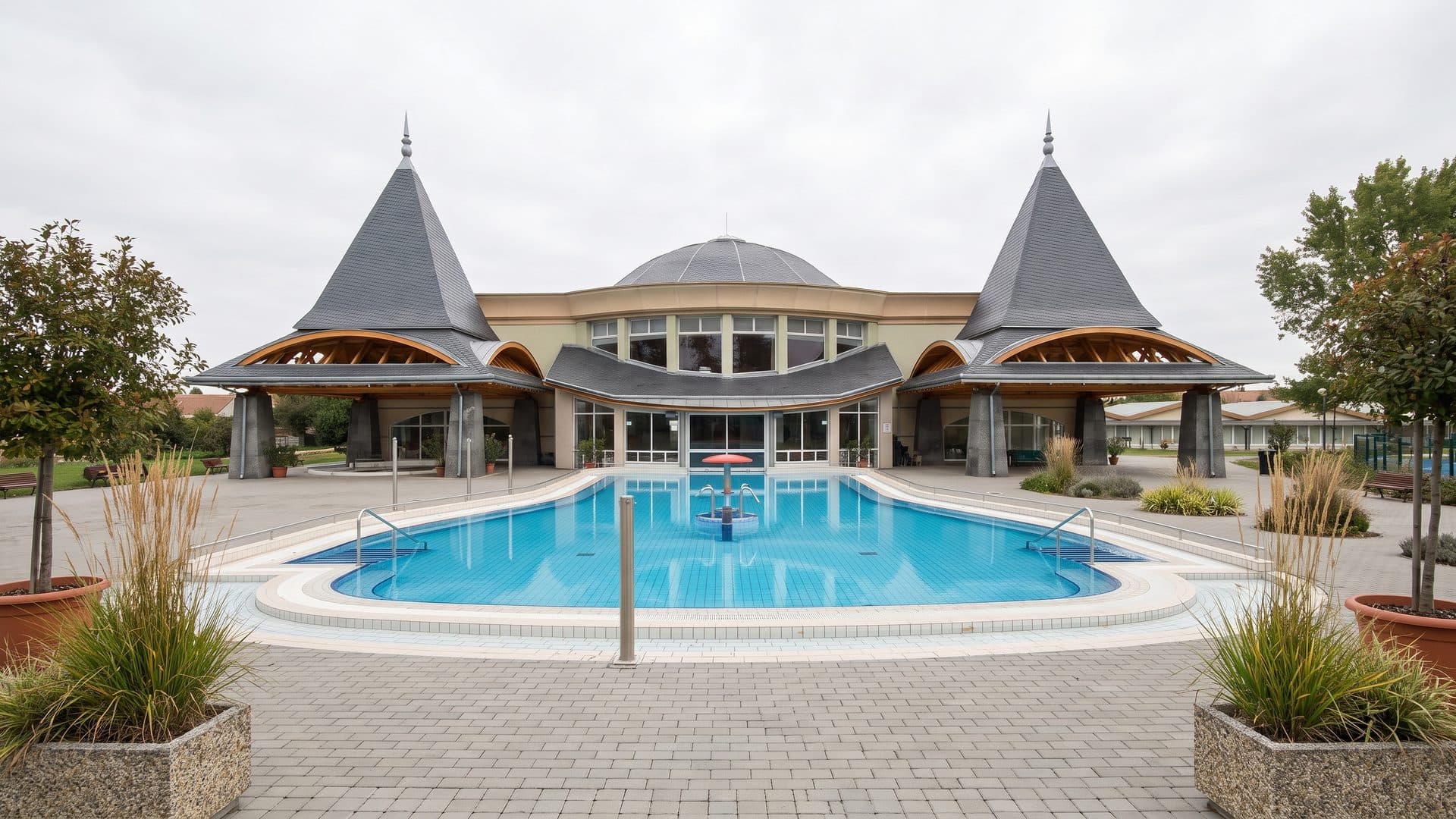 The outdoor pool of the Szigetvar baths in front of the turreted bath pavilion