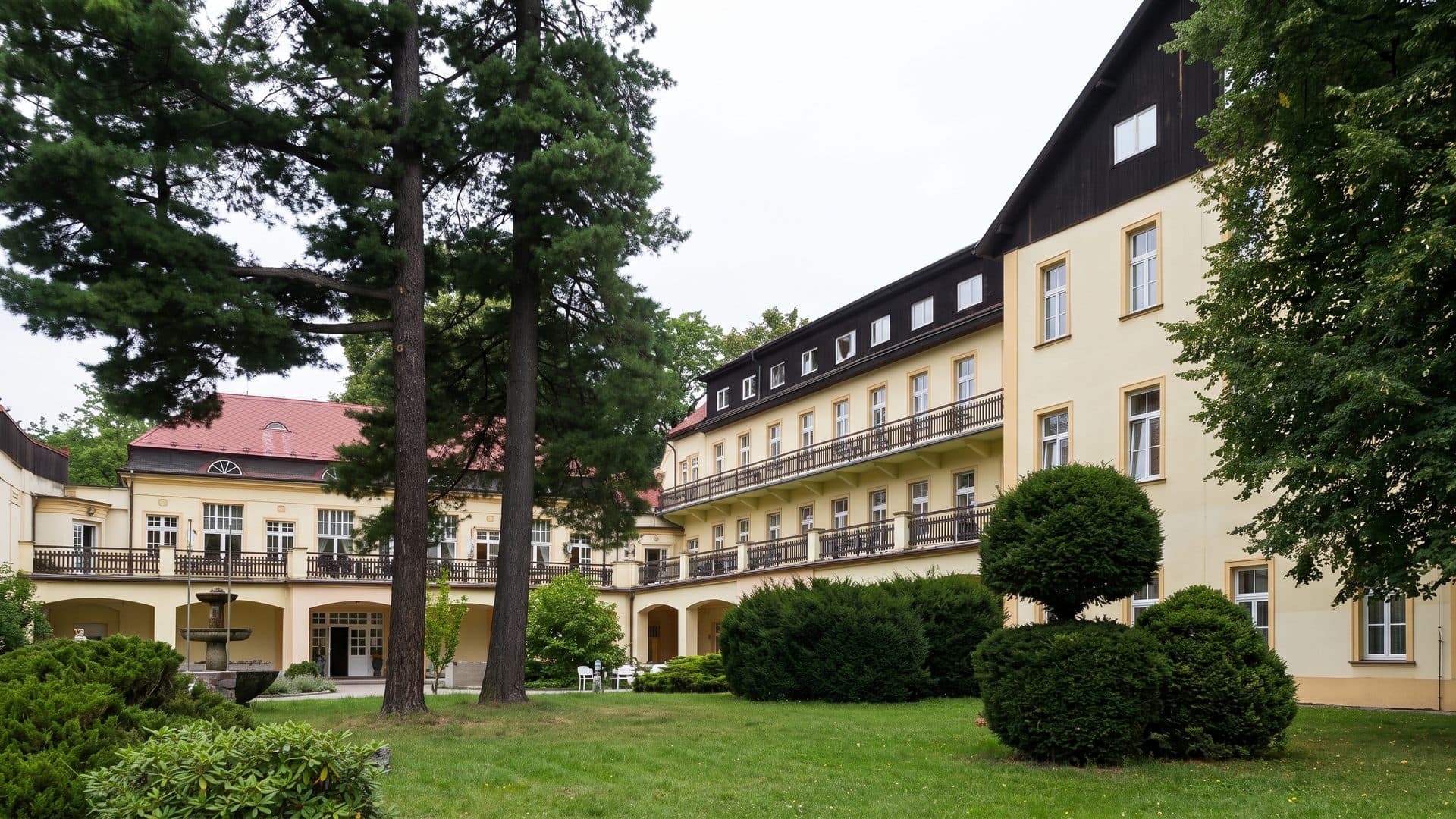 The spa house of Tereziny lazne seen across its park lawn