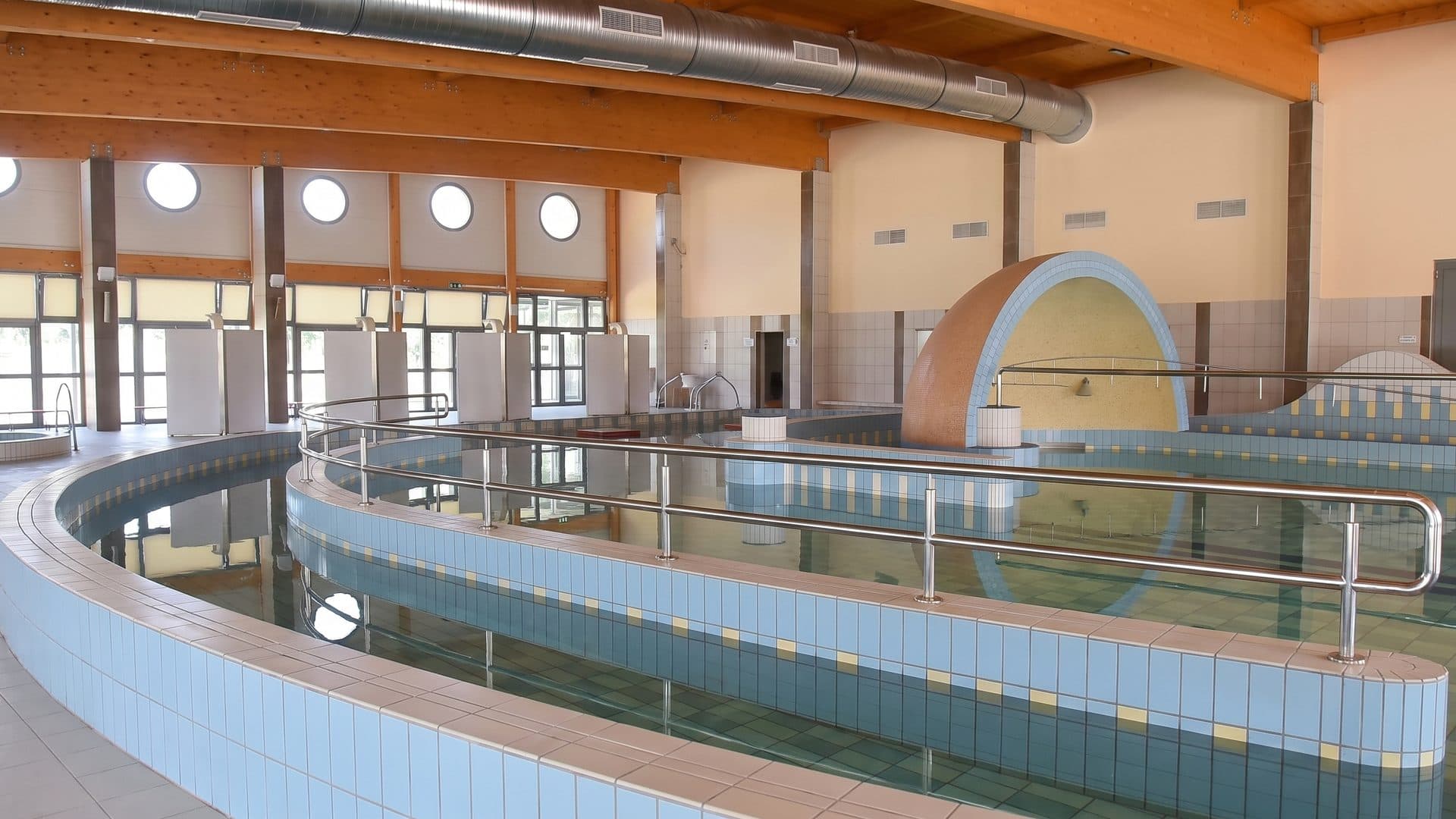 The thermal pool of the baths with its handrails under the hall ceiling