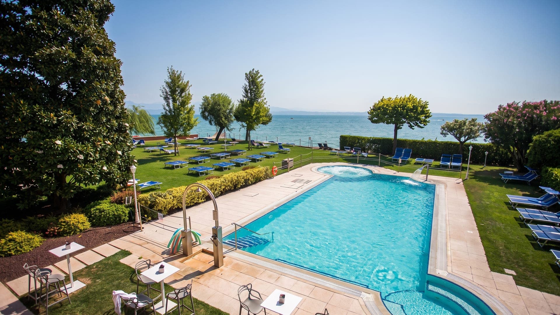 Pool set in the lawn above Lake Garda