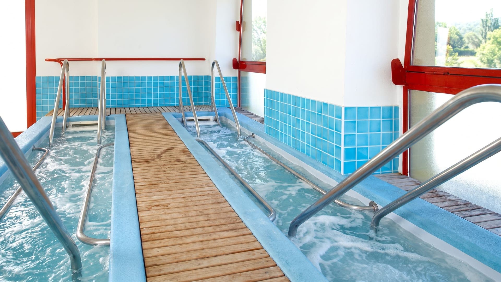 The walking channels at the Terme di Trescore, their blue-tiled troughs on either side of a timber walkway.